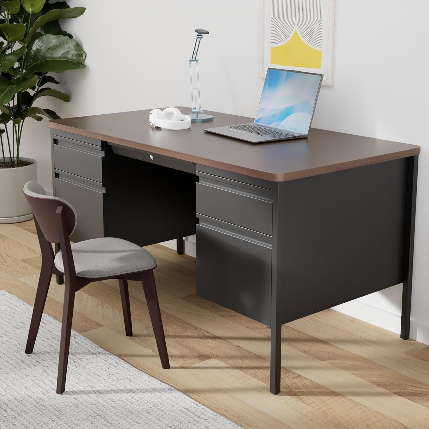 Modern office desk with laptop, chair, and plant in a room setting