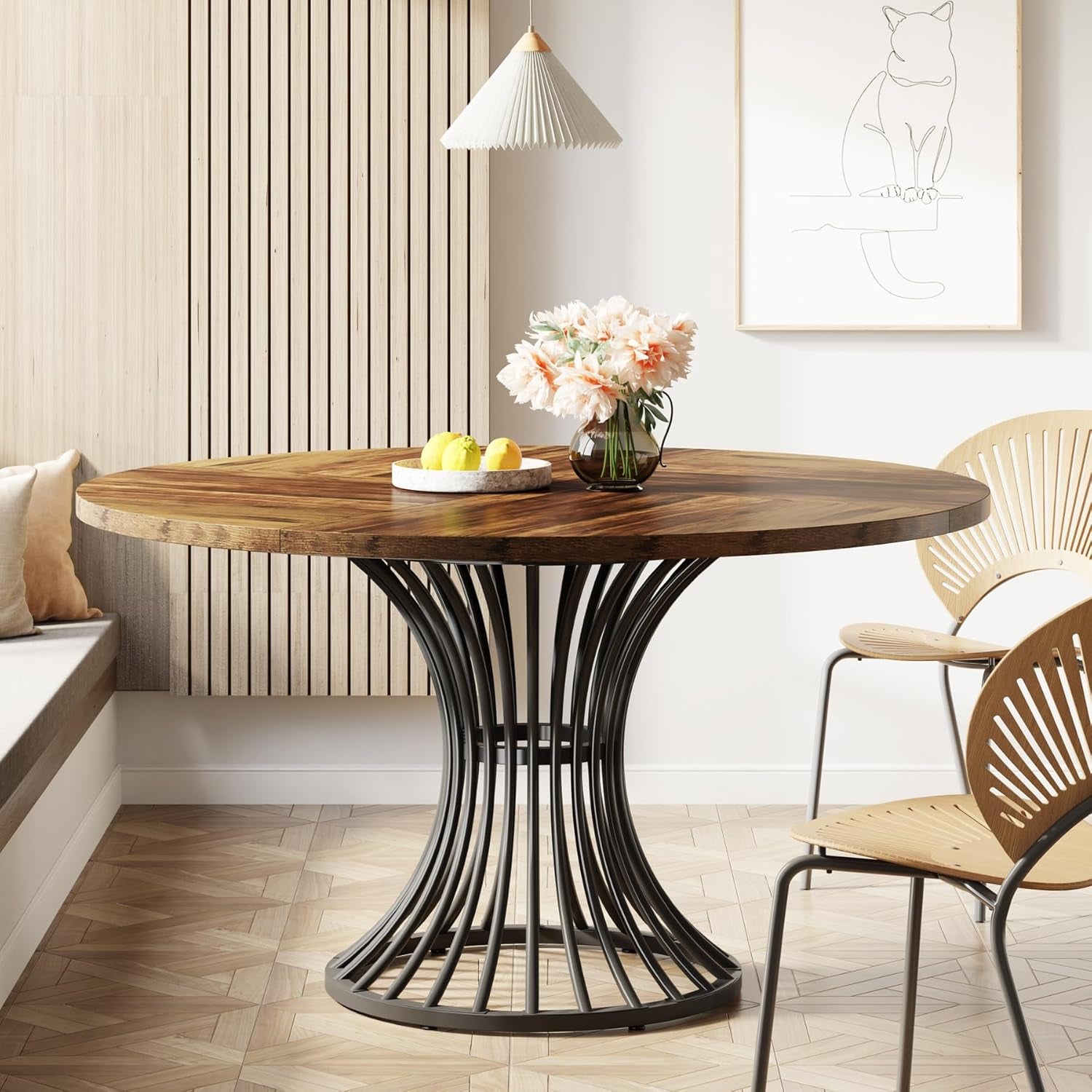 Dining table with wooden top and black metal base in a modern interior setting.