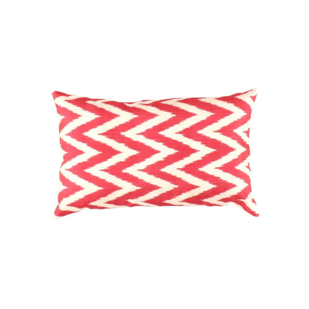 Red and white chevron patterned pillow on a white background