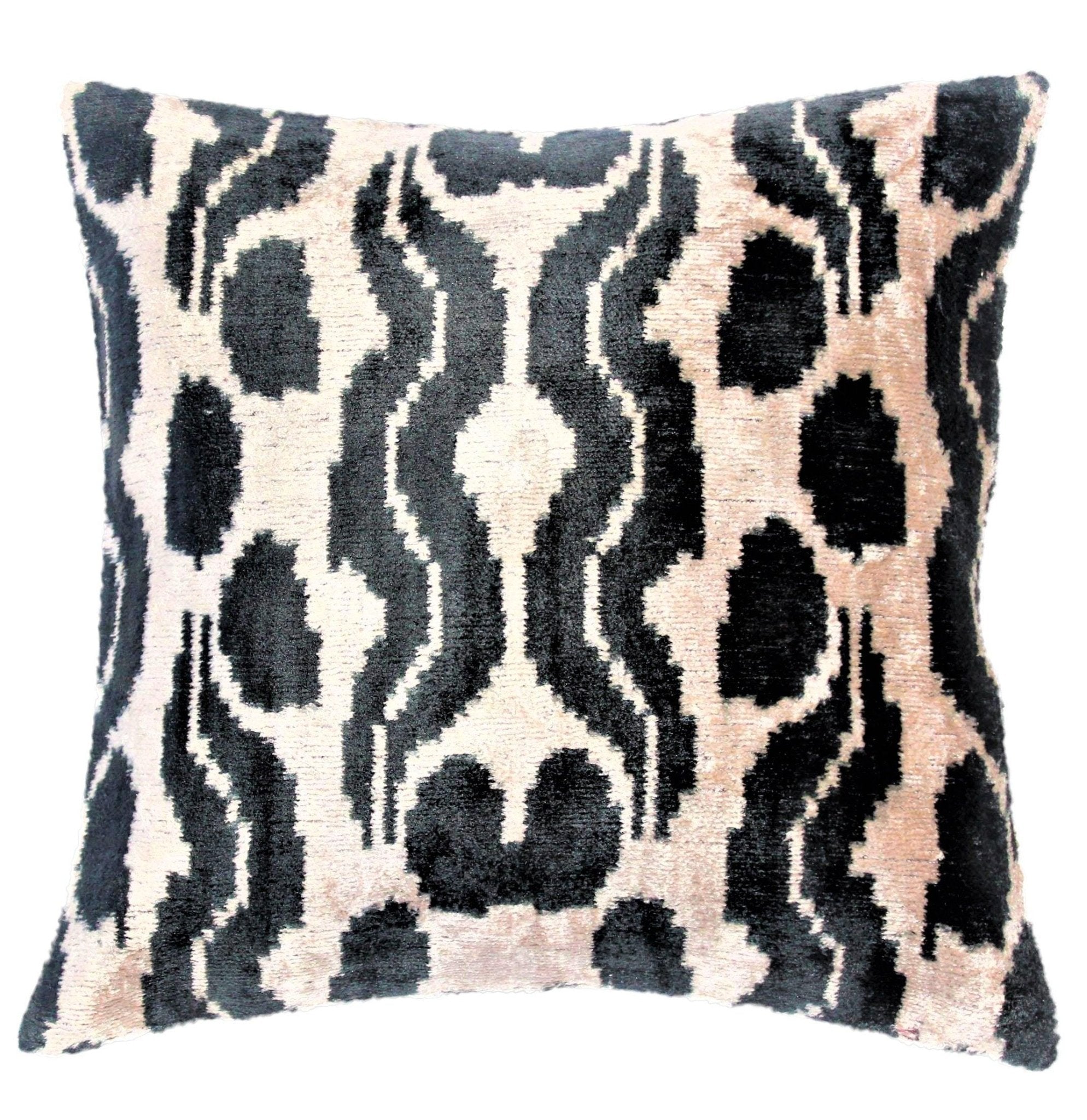 Decorative pillow with a black and beige abstract pattern on a white background