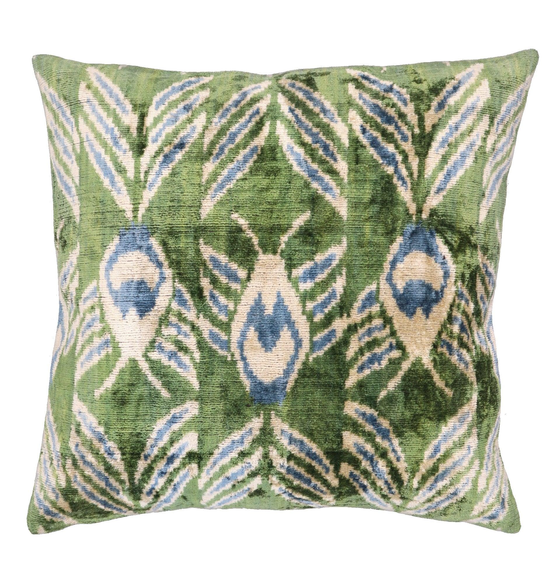 Decorative pillow with peacock feather pattern on a green background