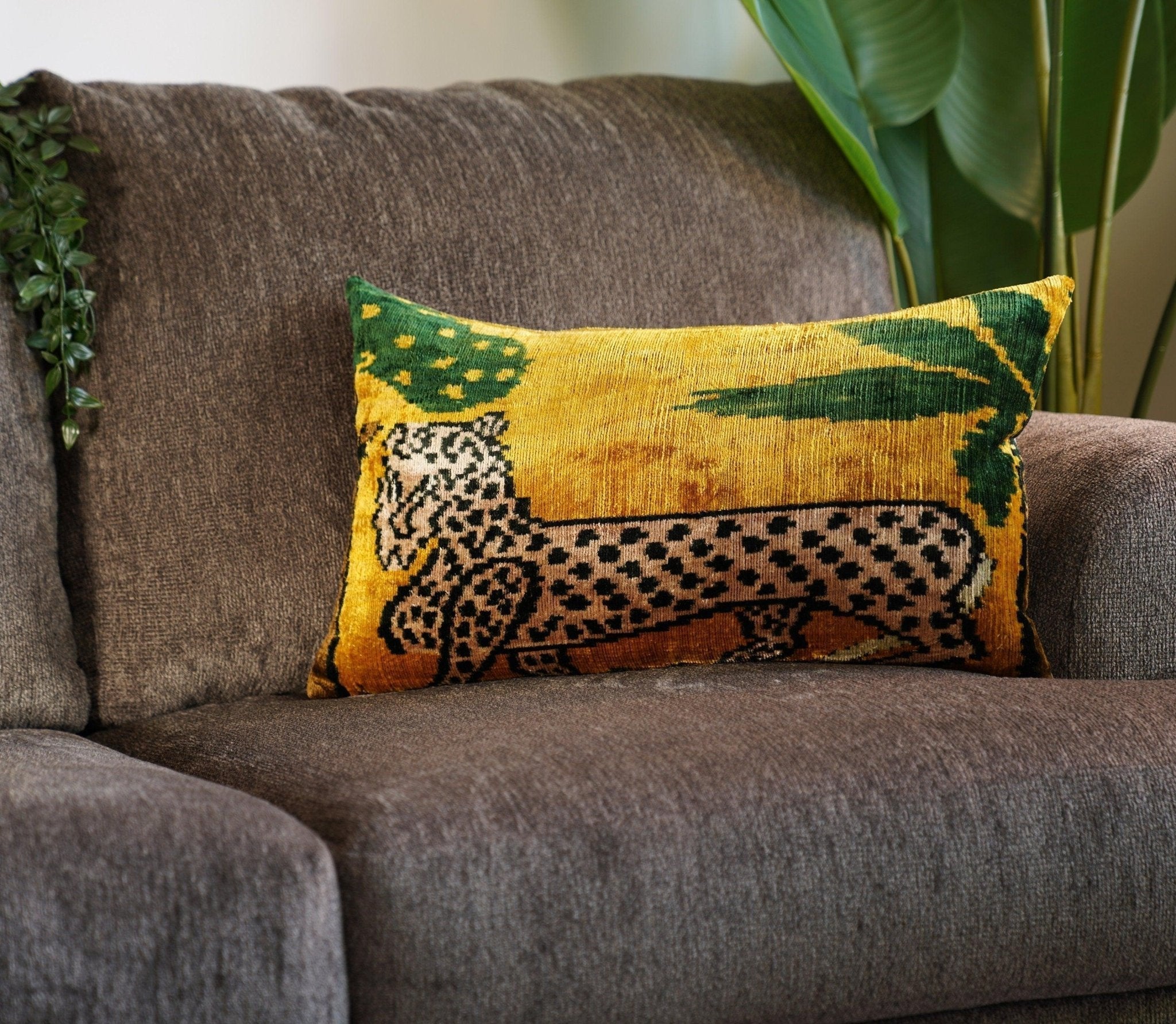 Decorative pillow with a leopard design on a gray couch