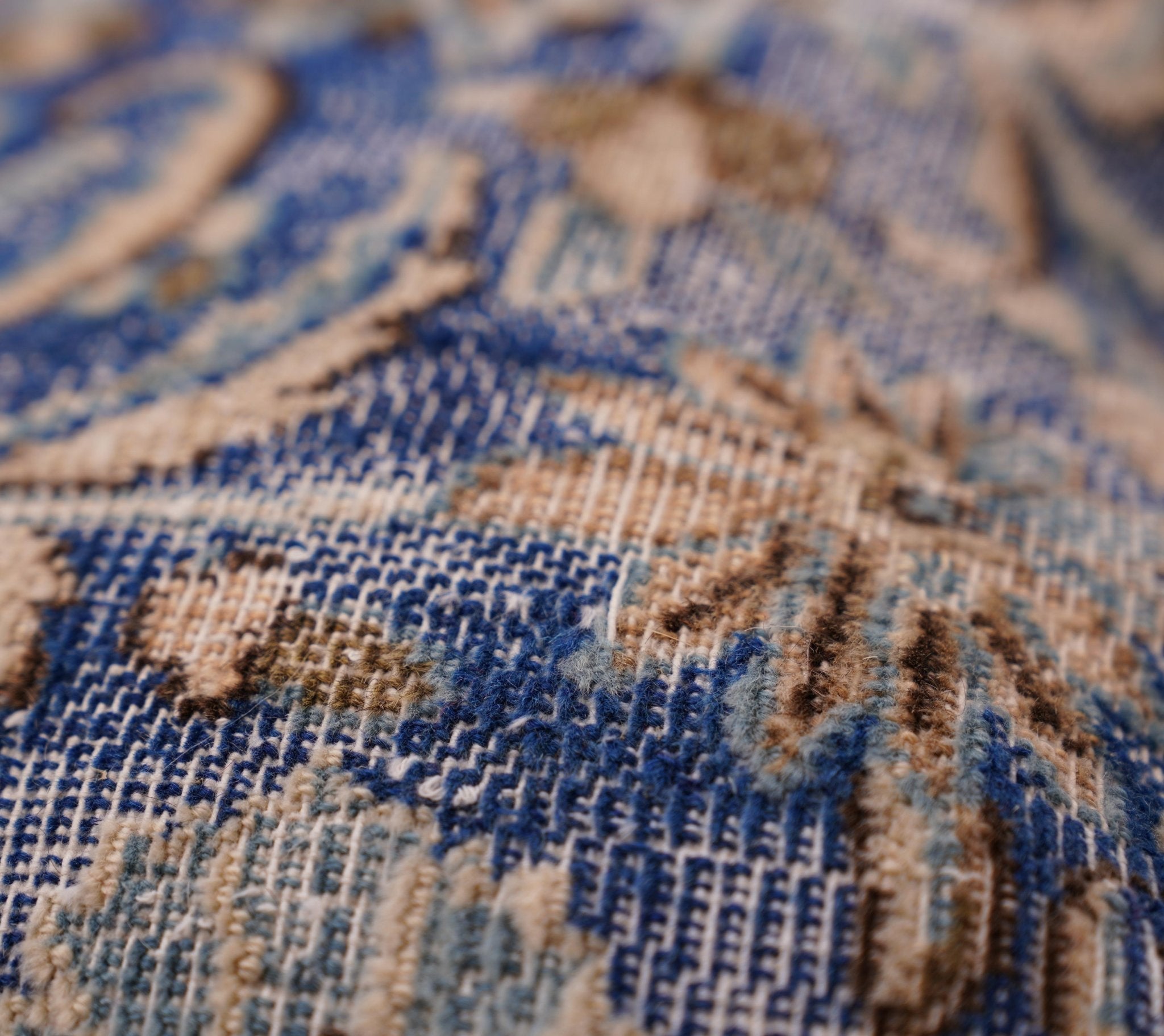 Close-up of a textured fabric with blue and beige pattern