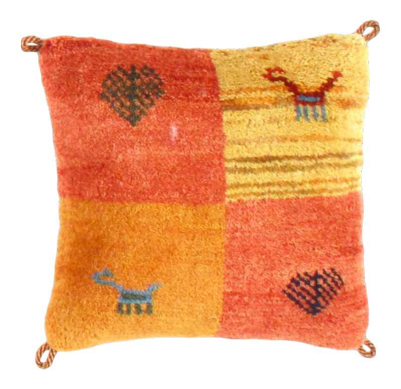 Patchwork pillow with animal and heart designs on a white background