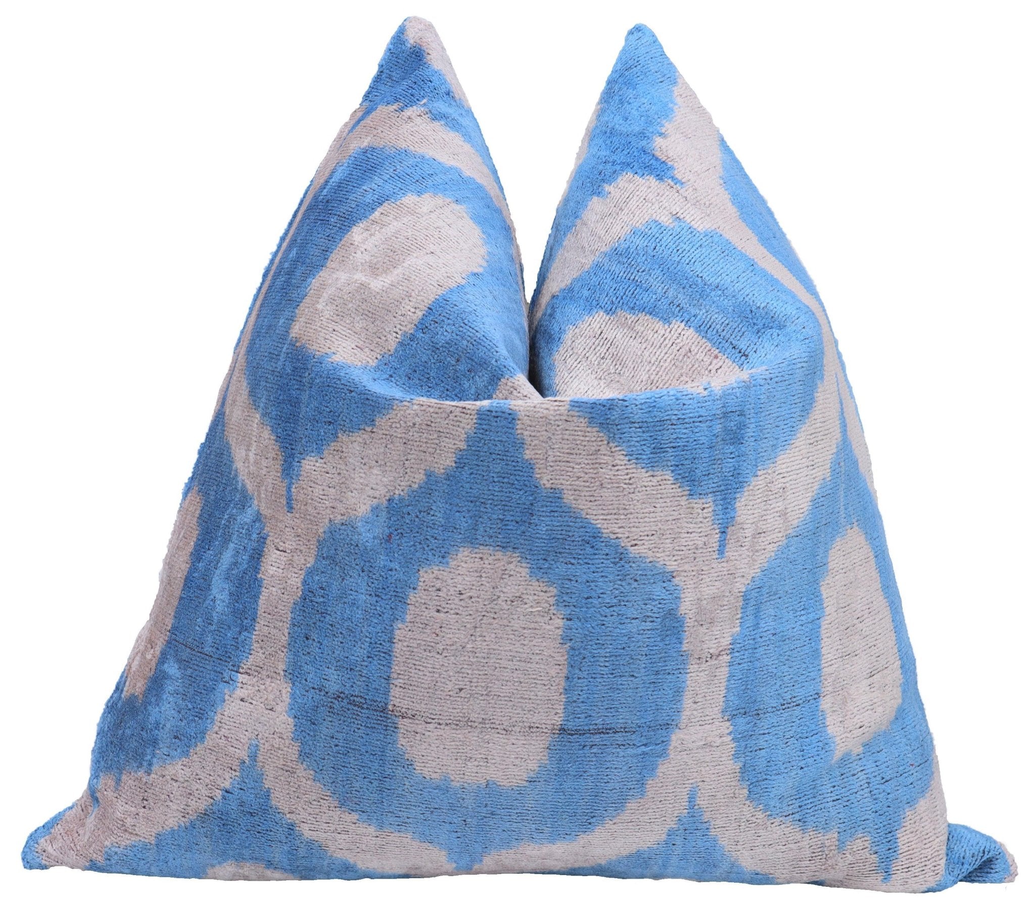 Pair of blue and gray patterned pillows on a white background