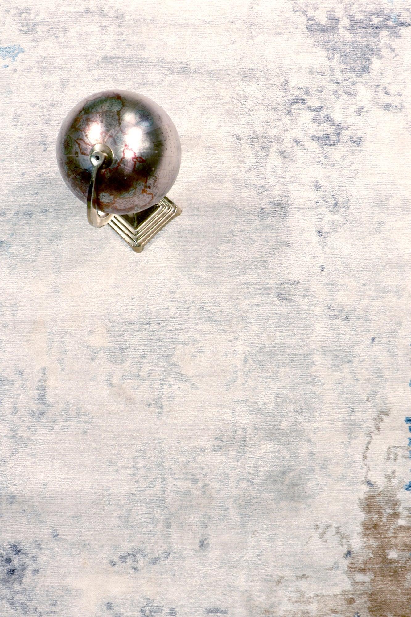 Silver earring on a textured gray background