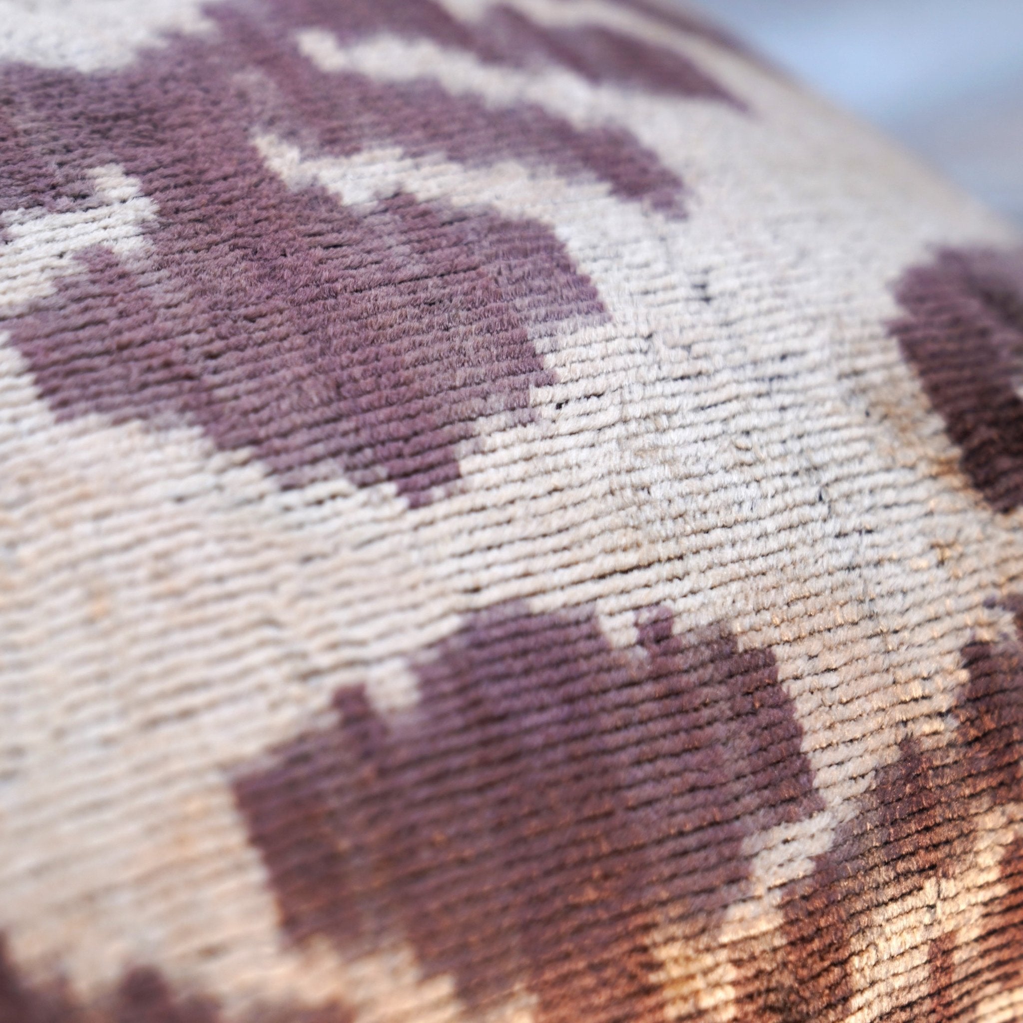 Close-up of a textured fabric with brown and beige pattern