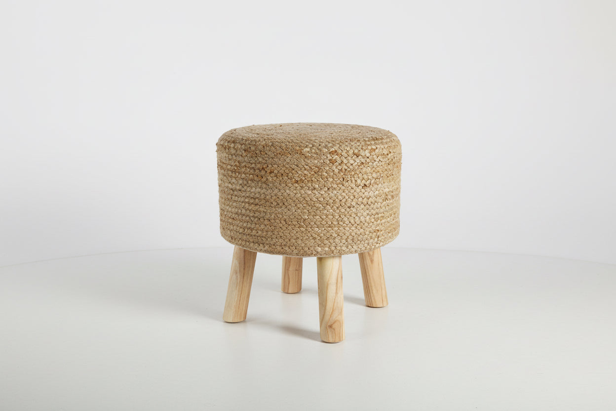 Round woven stool with wooden legs on a white background