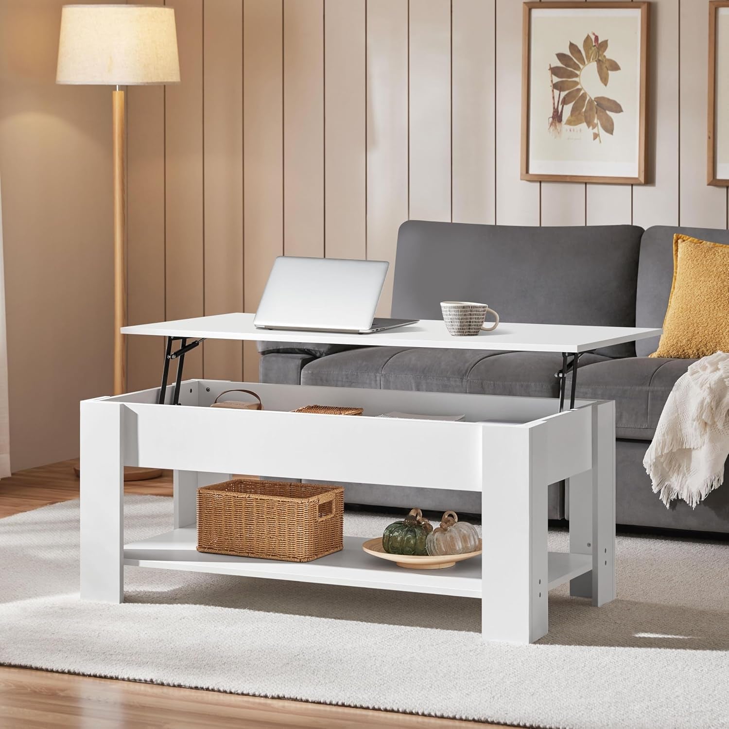 Living room with a white coffee table, gray sofa, and decorative items.