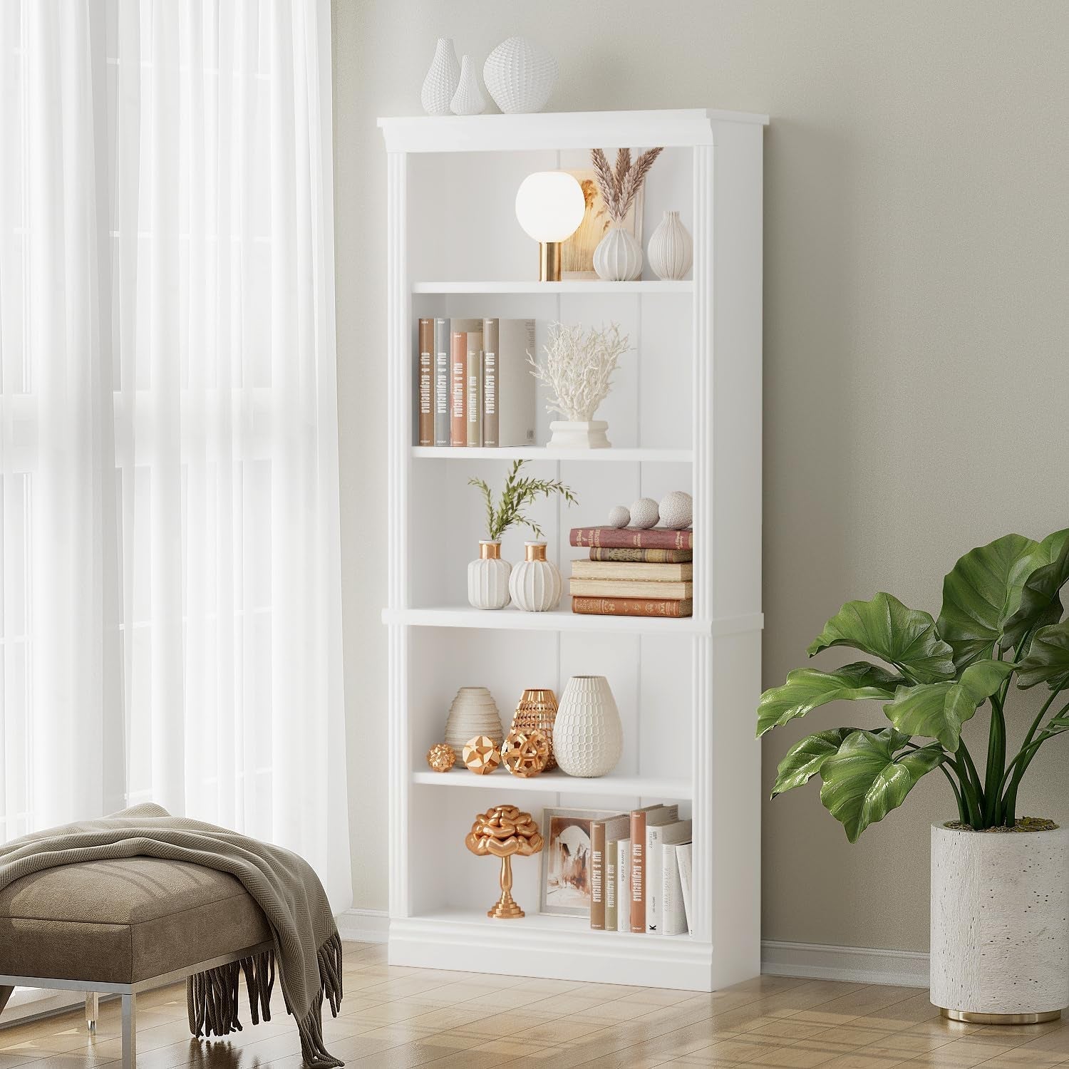White bookshelf with decorative items in a room with a plant and bench.