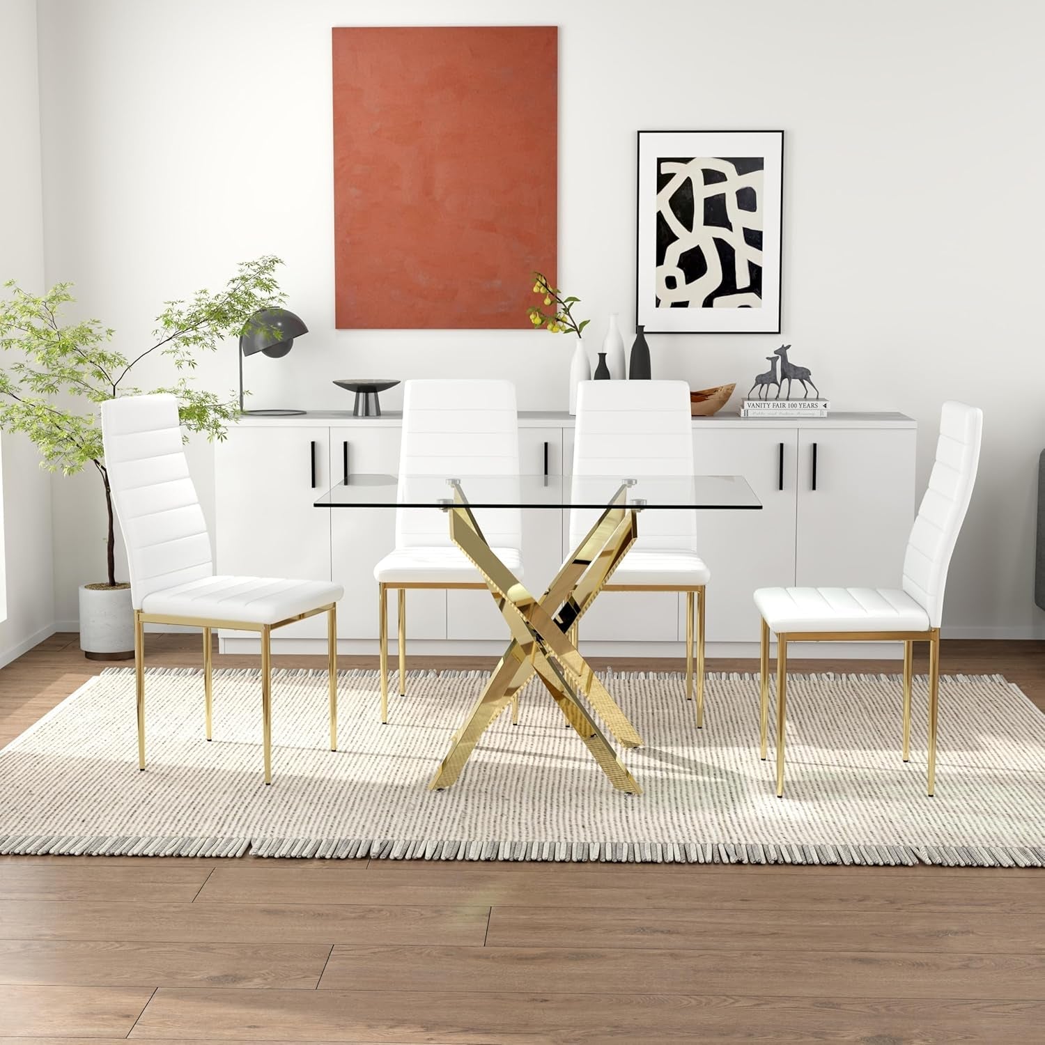 Modern dining room with glass table and white chairs in a well-lit room.