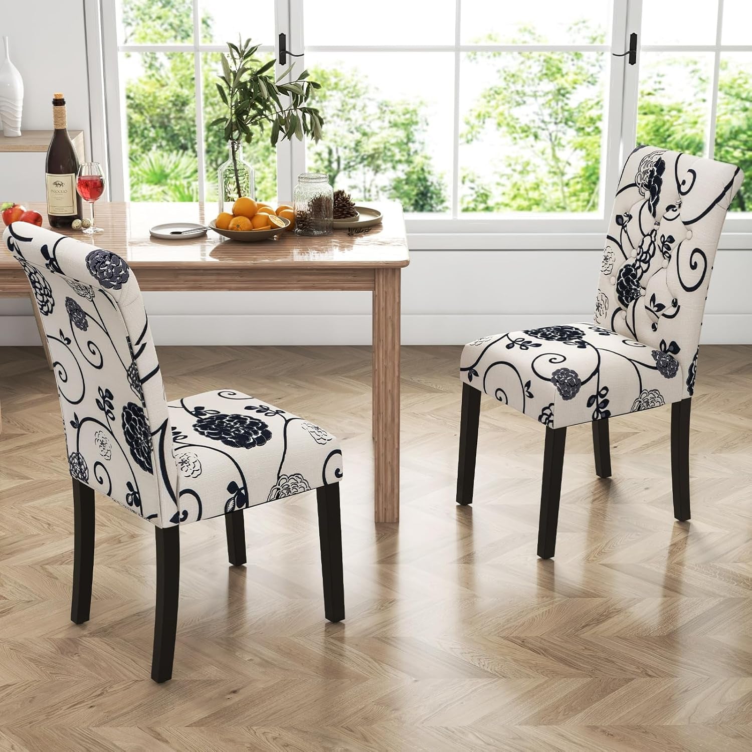 Dining room with floral-patterned chairs and a table by a window.
