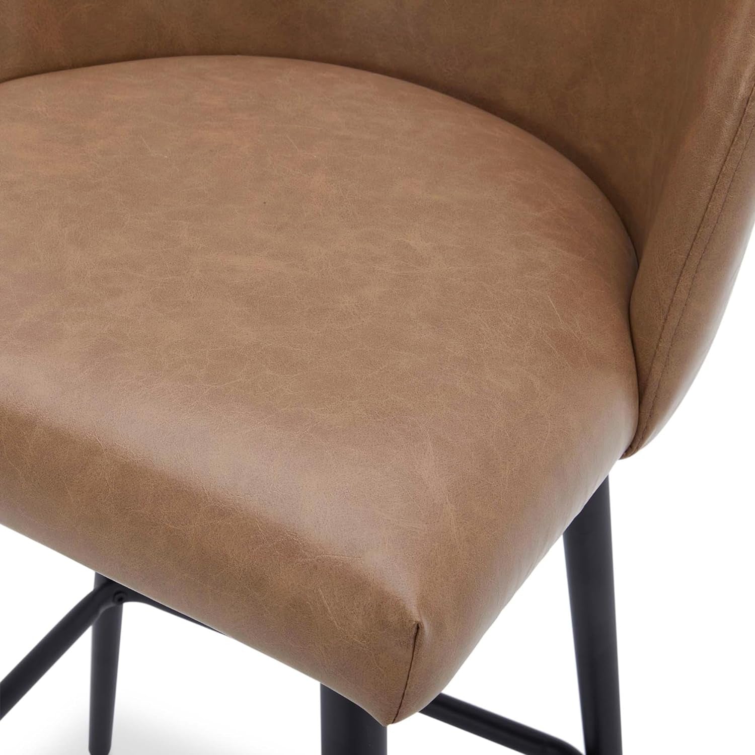 Close-up of a brown leather chair seat with black metal legs on a white background