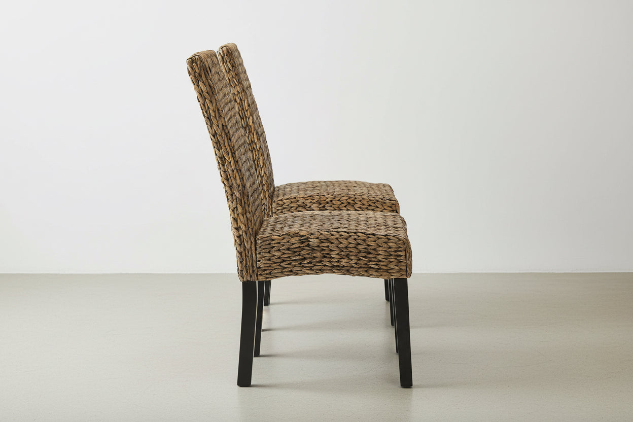 Wicker chair with black legs on a white background
