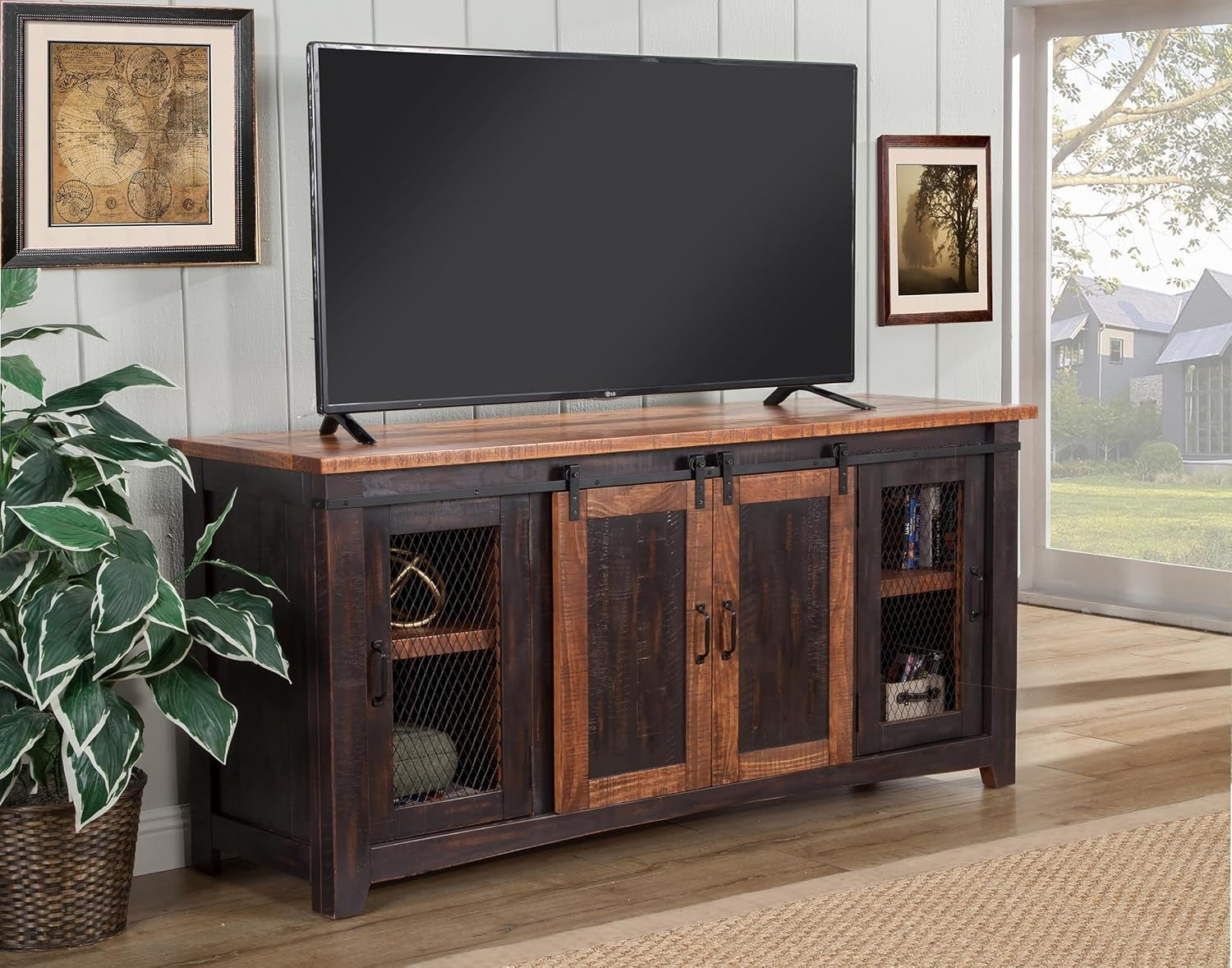 Wooden TV stand with a television on top, surrounded by decor elements in a room.