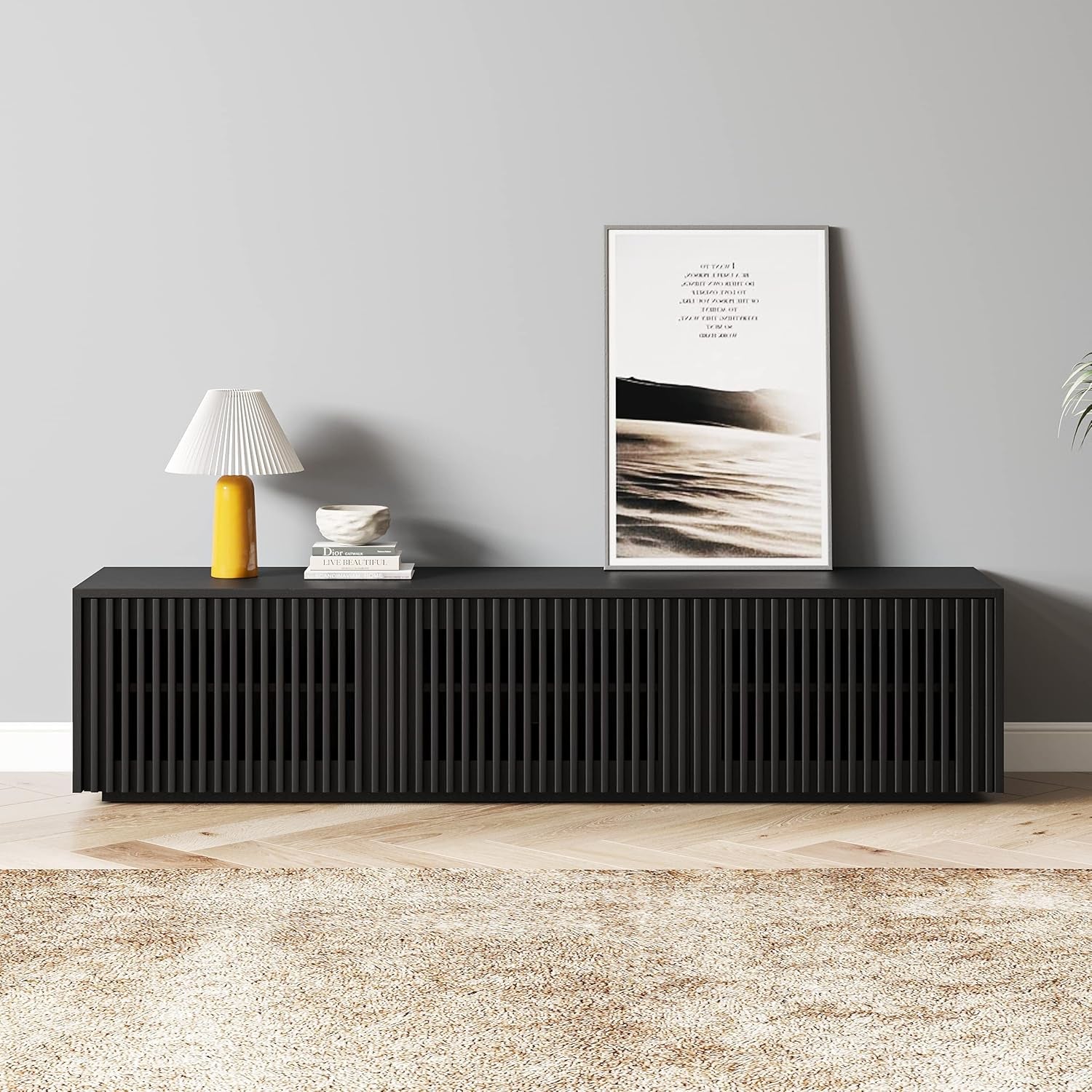 Black console table with decorative items against a gray wall
