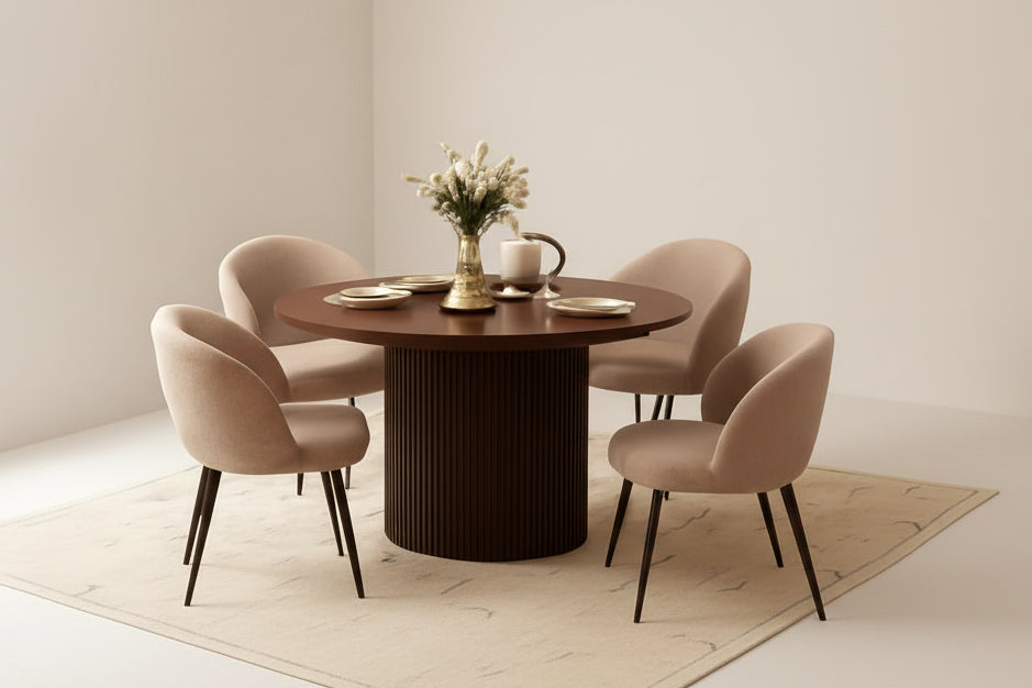 Dining room with a round wooden table and four beige chairs.