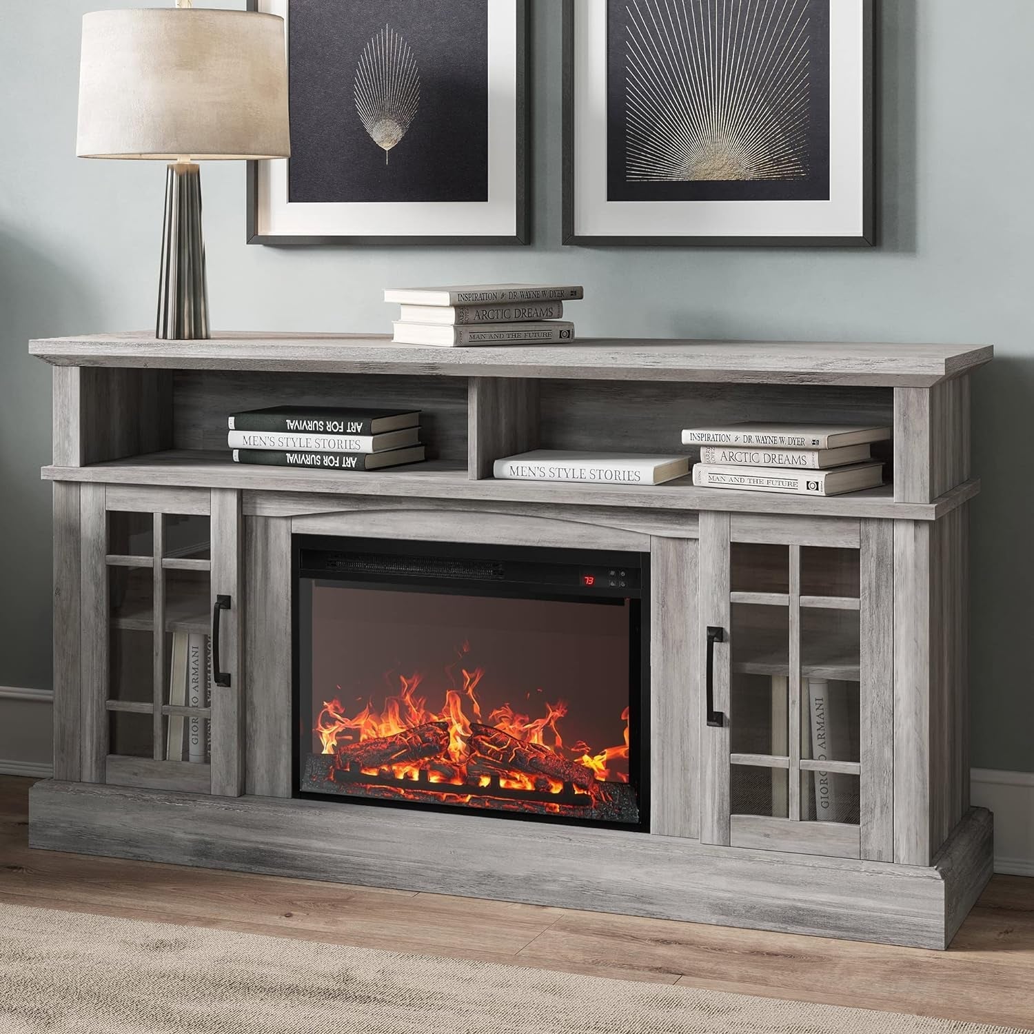 Wooden entertainment console with electric fireplace and books in a living room setting.