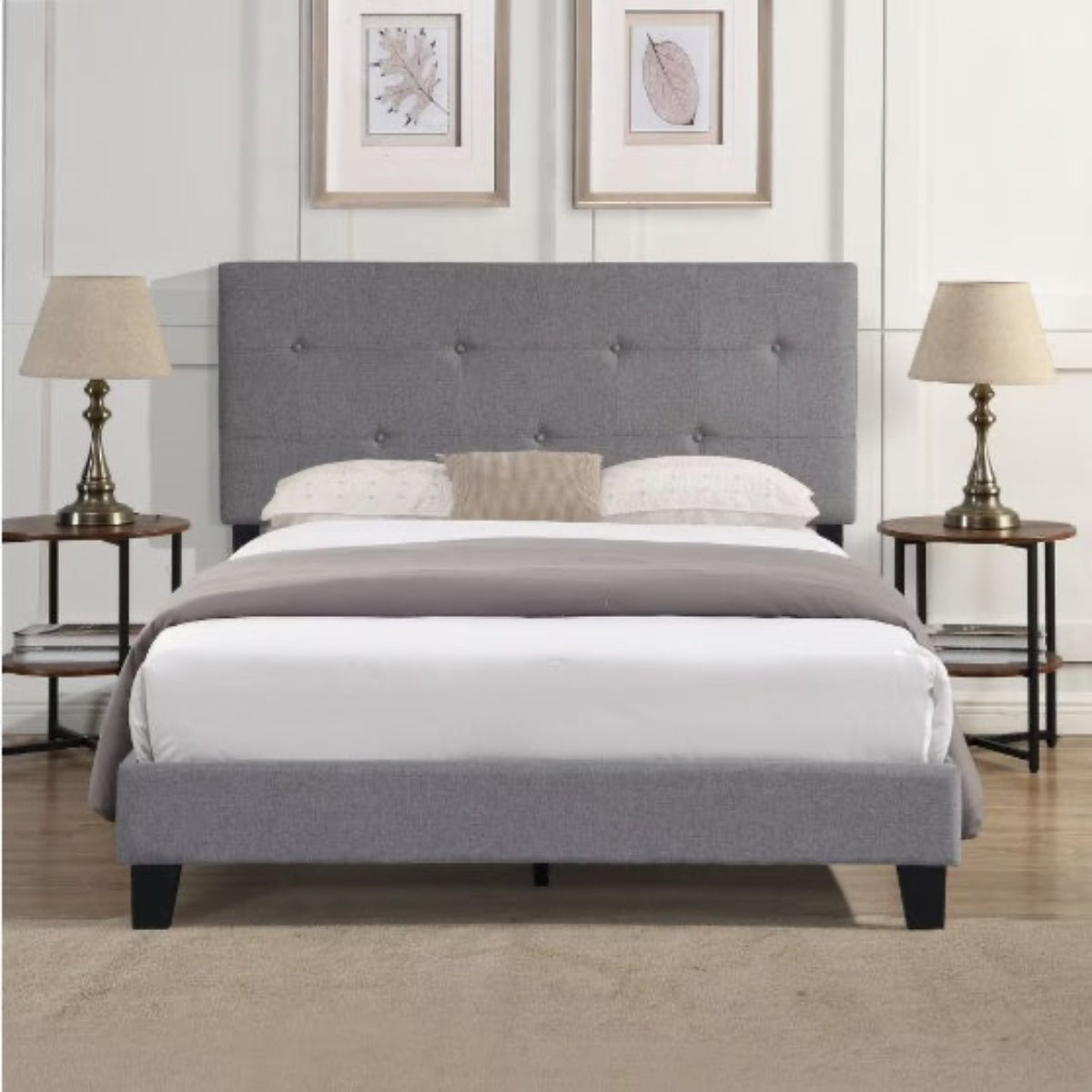 Gray upholstered bed with white bedding in a bedroom setting.