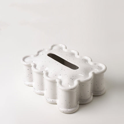 Speckled white ceramic tumbler set on a light gray background