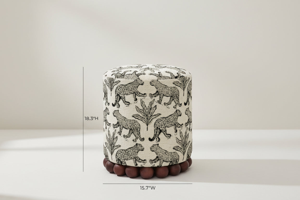 Patterned ottoman with leopard design and wooden feet on a white background