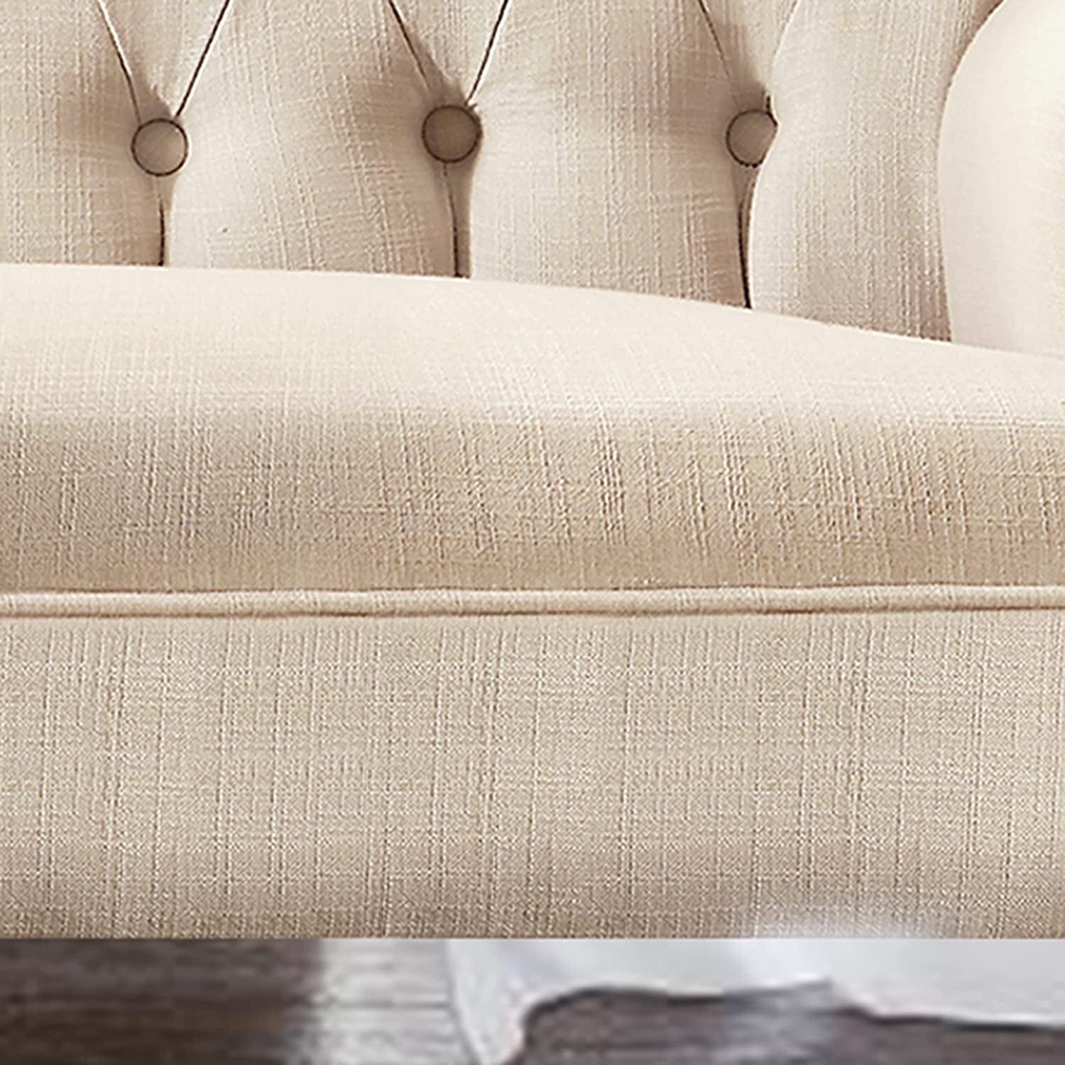 Close-up of a beige upholstered headboard with tufted design