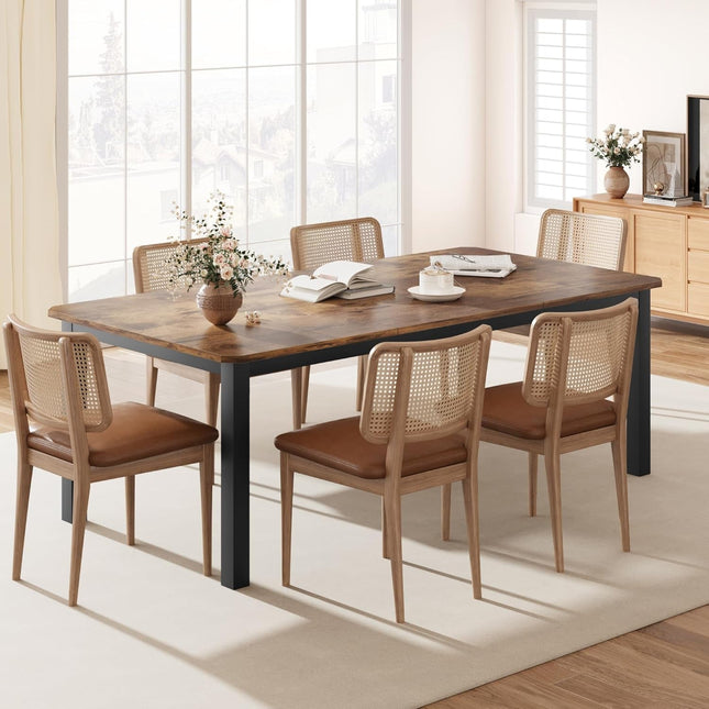 Dining room with a wooden table and chairs in a bright room.