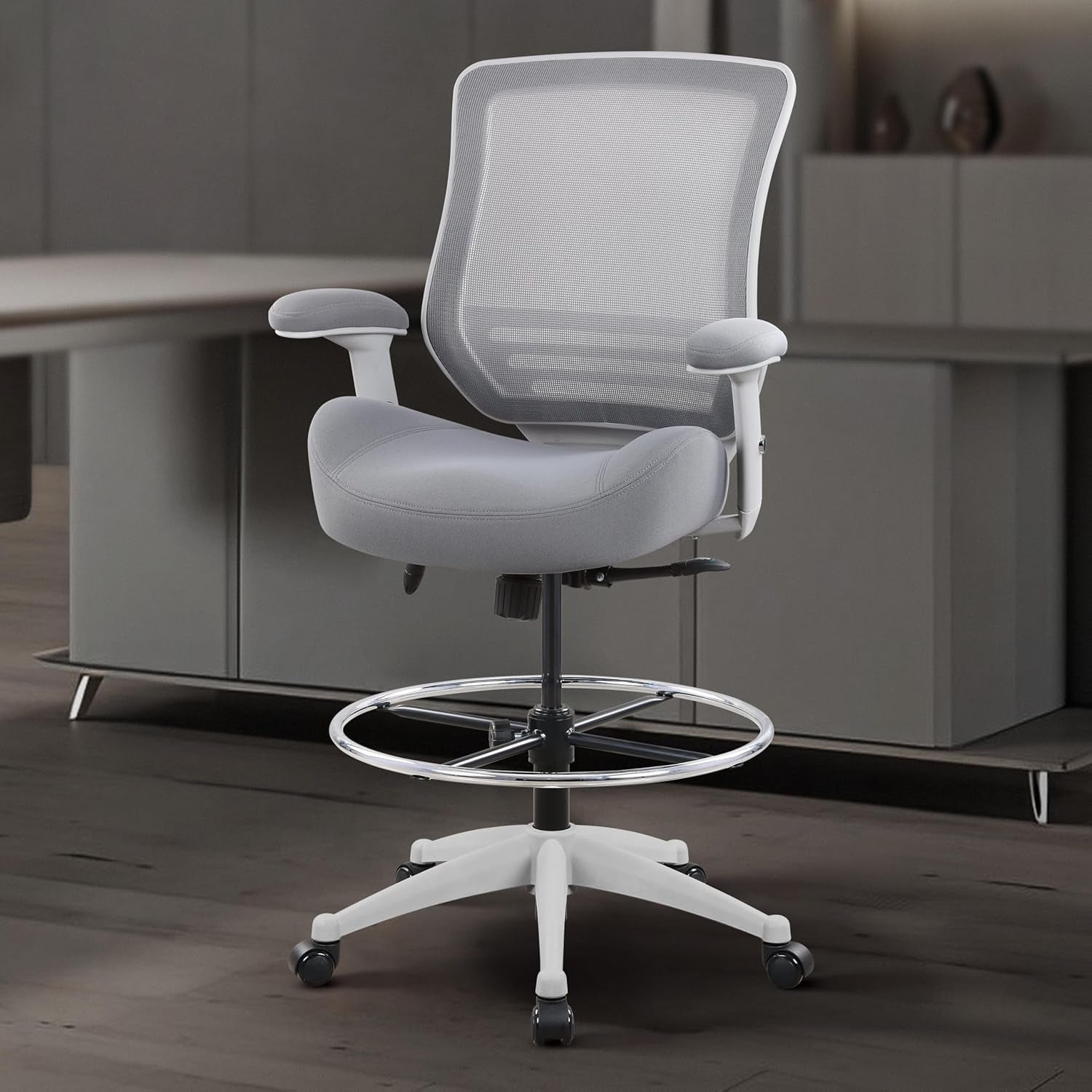 Gray office chair with mesh backrest in a modern office setting