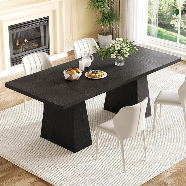 Dining room with a black marble table and white chairs, featuring a fireplace and large window.