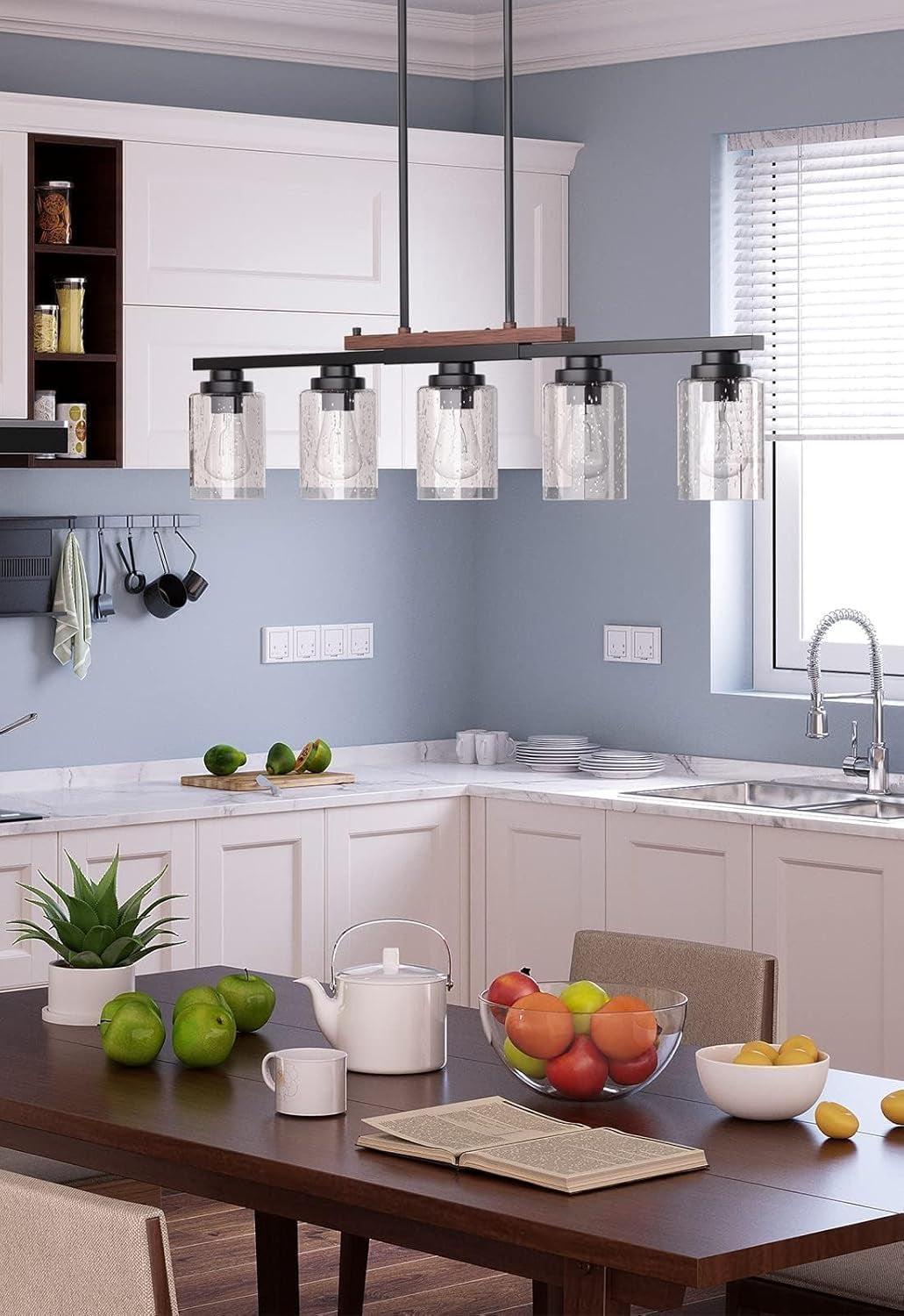 Modern kitchen with a dining table set, fruit bowl, and kitchen appliances.