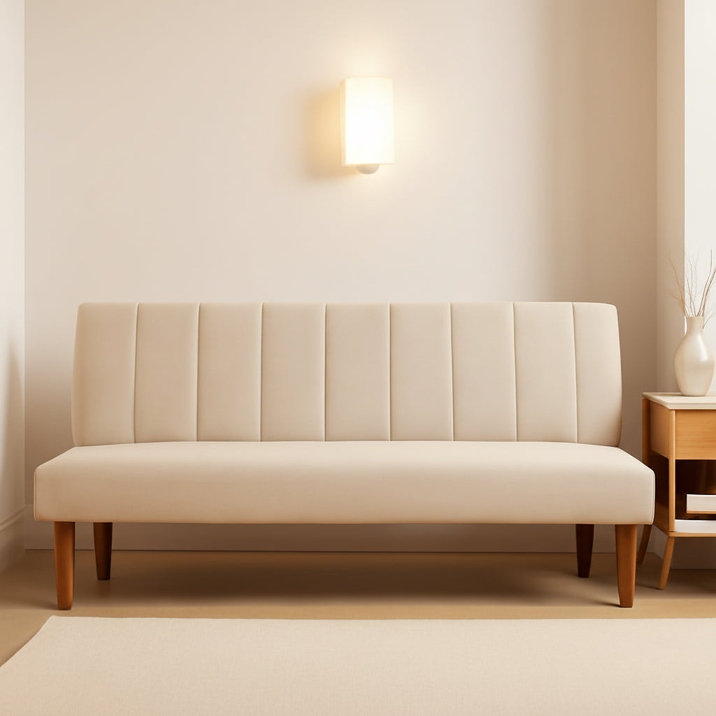 Beige sofa in a room with warm lighting and a side table.