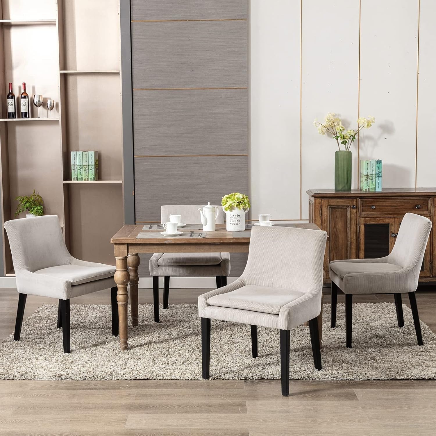 Dining room with a wooden table and gray chairs in a modern interior setting.