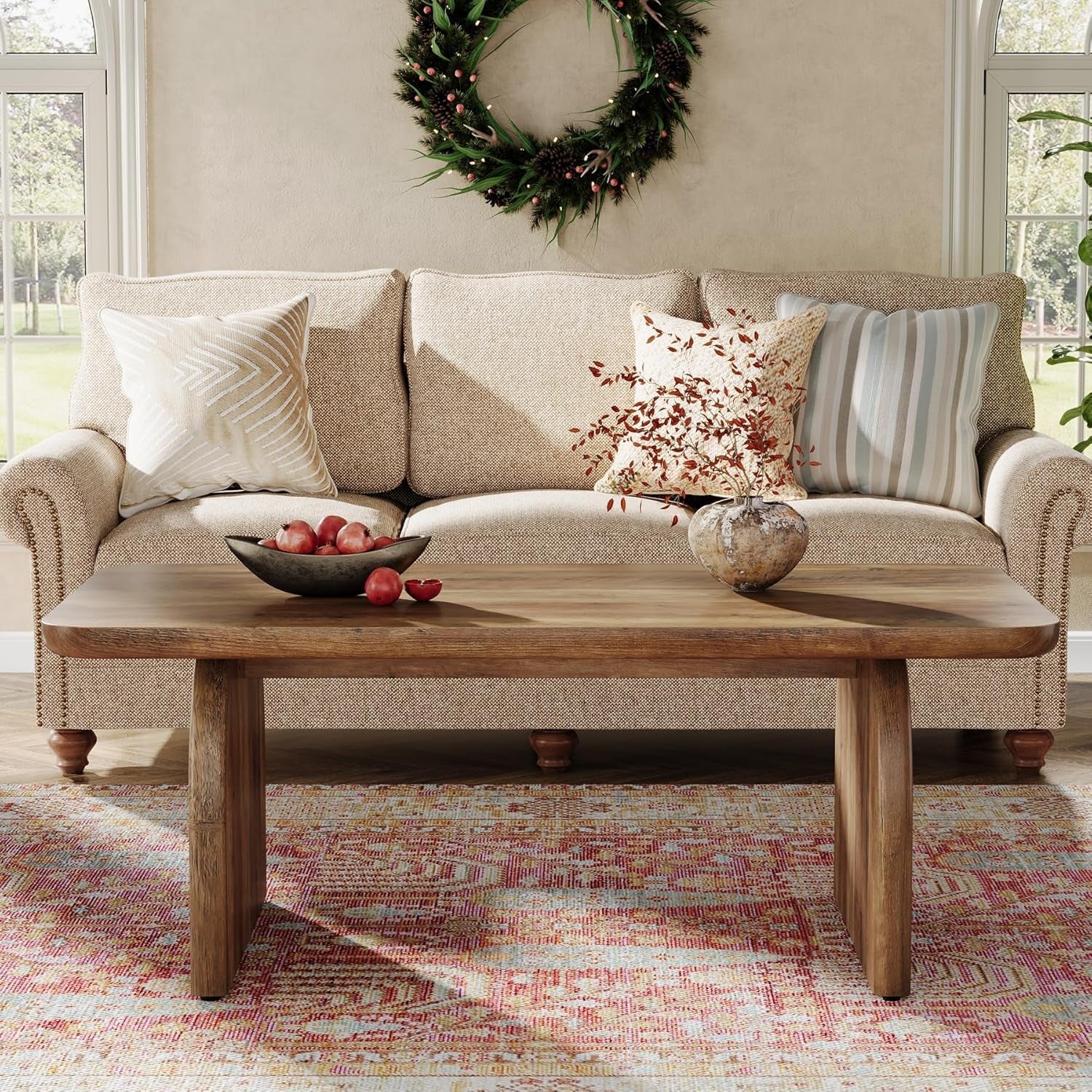 Living room with a beige sofa, wooden coffee table, and decorative wreath on the wall.