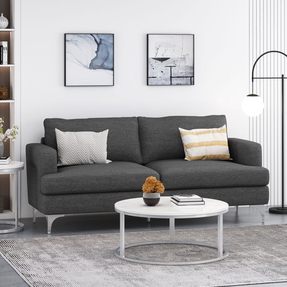 Gray sofa in a living room with a white coffee table and decorative items.