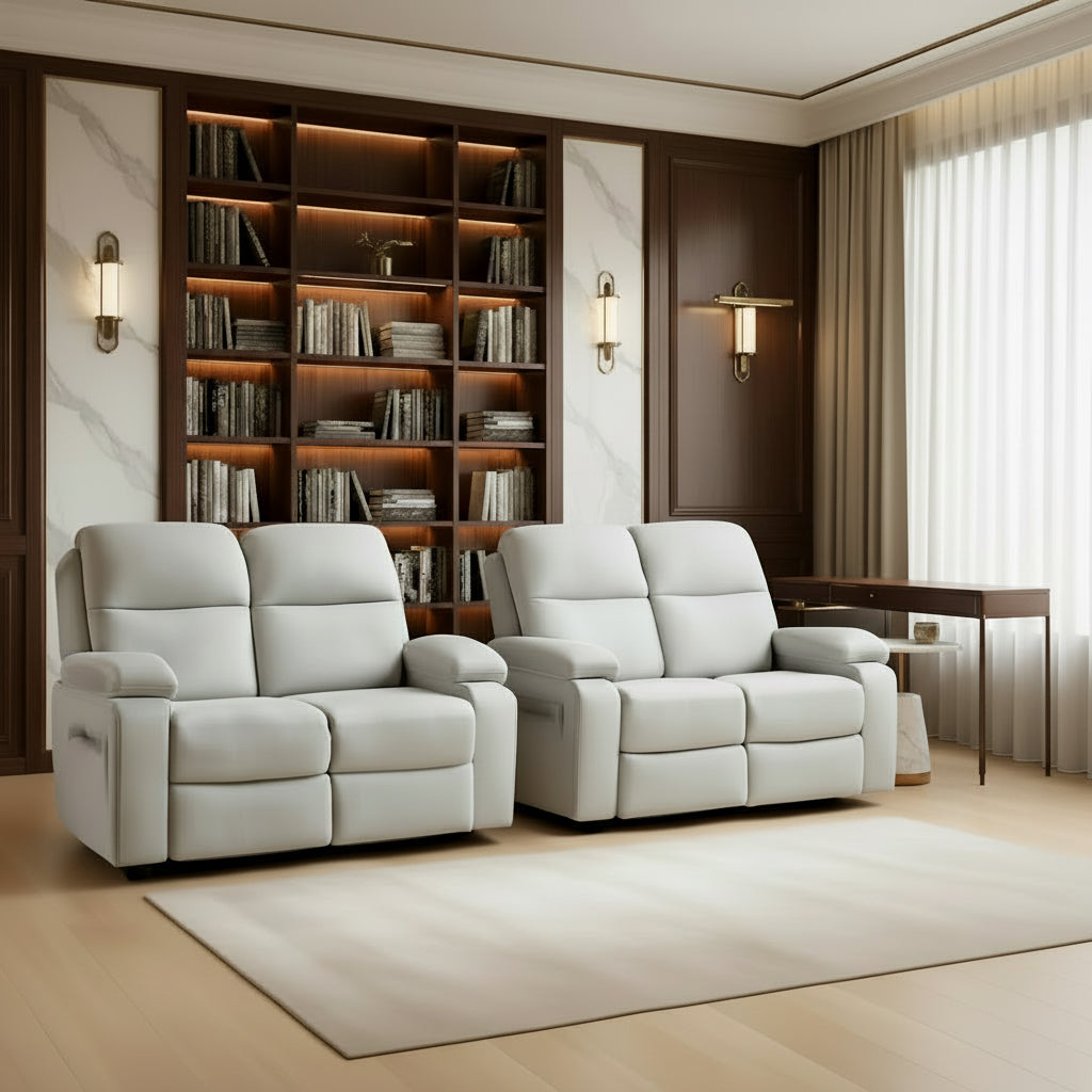 Two gray recliner sofas in a living room setting with warm lighting.
