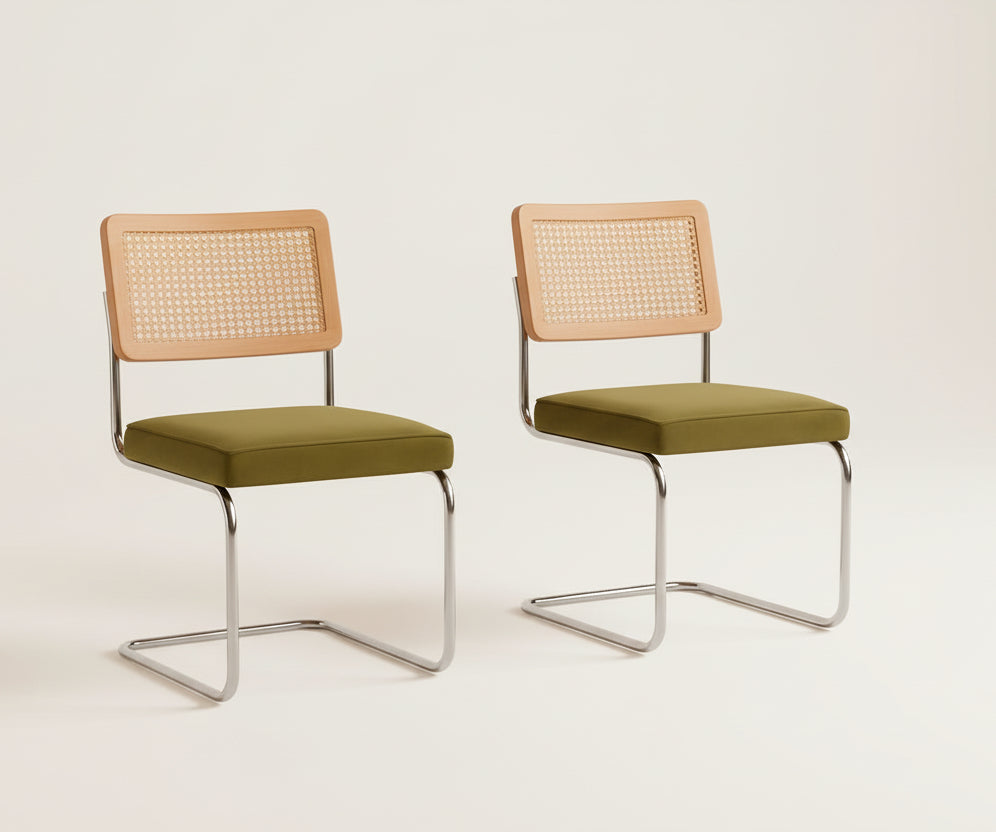 Two chairs with green seats and beige backrests in a room with a beige wall and rug.