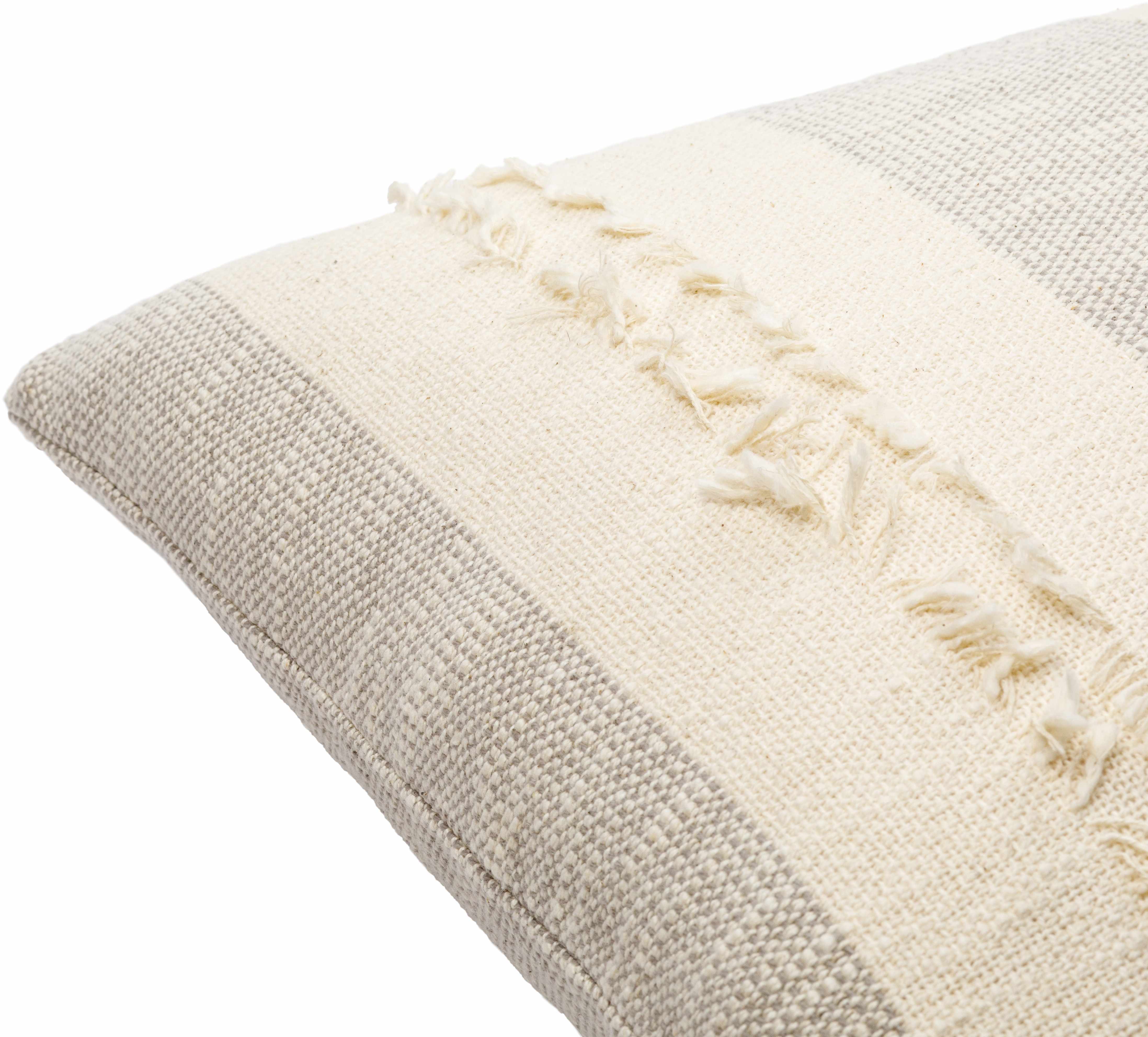 Textured beige pillow with decorative stitching on a white background