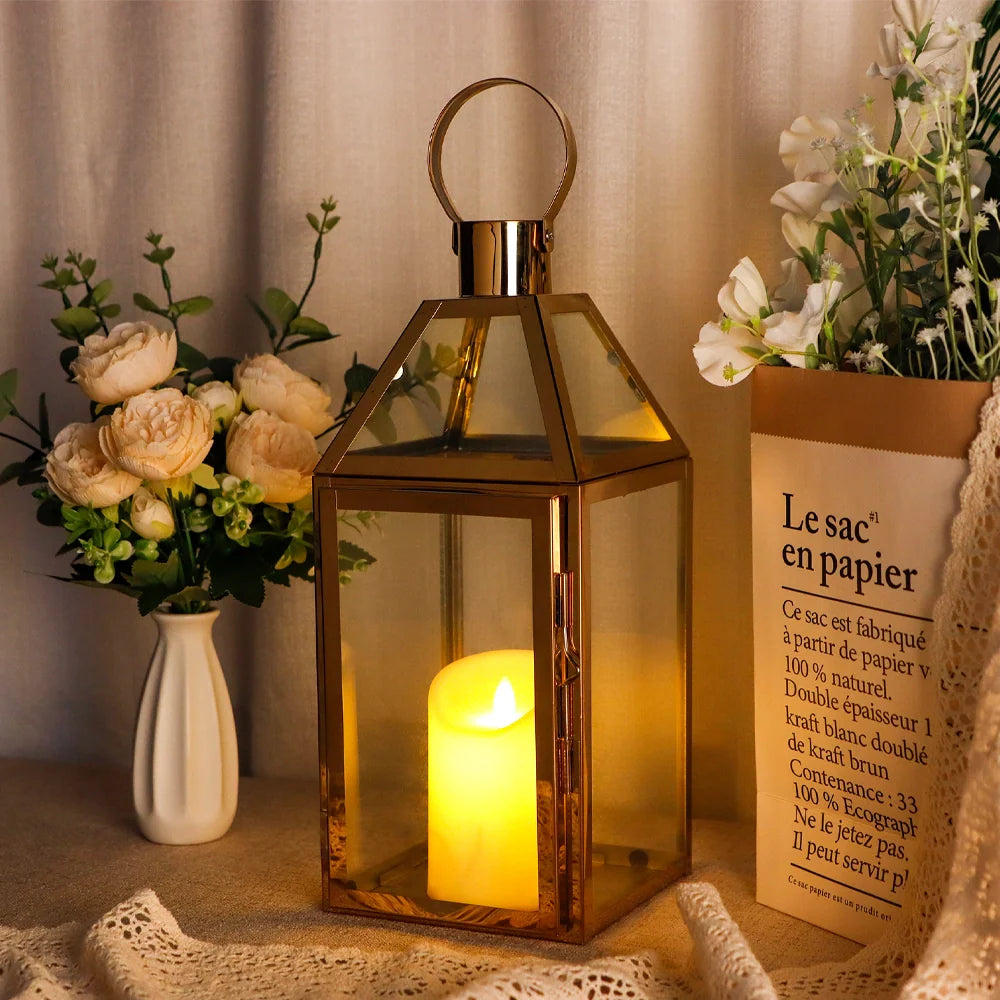 Decorative lantern with a lit candle, surrounded by flowers and a product box on a textured surface.