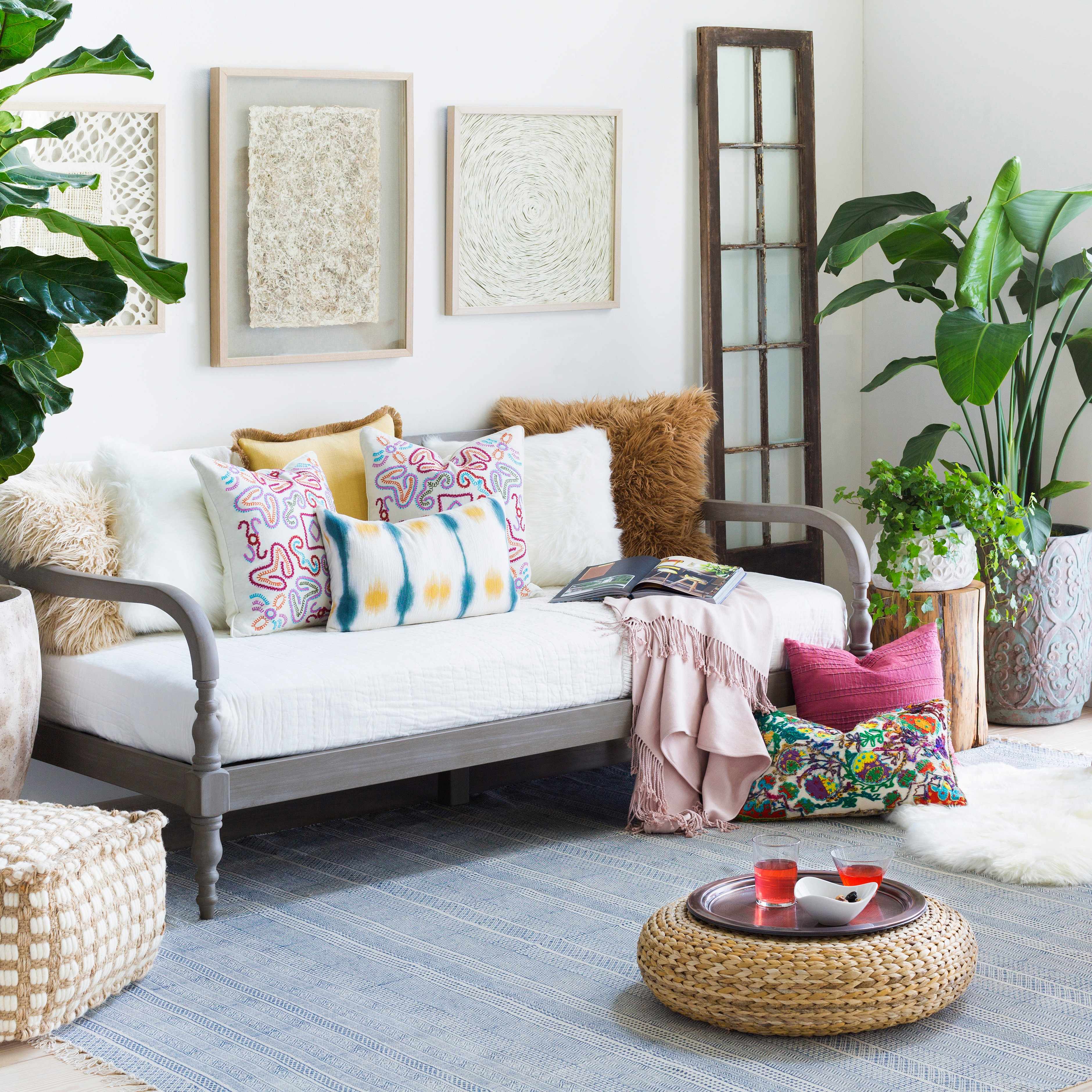 Cozy living room with a sofa, colorful pillows, and decorative items.
