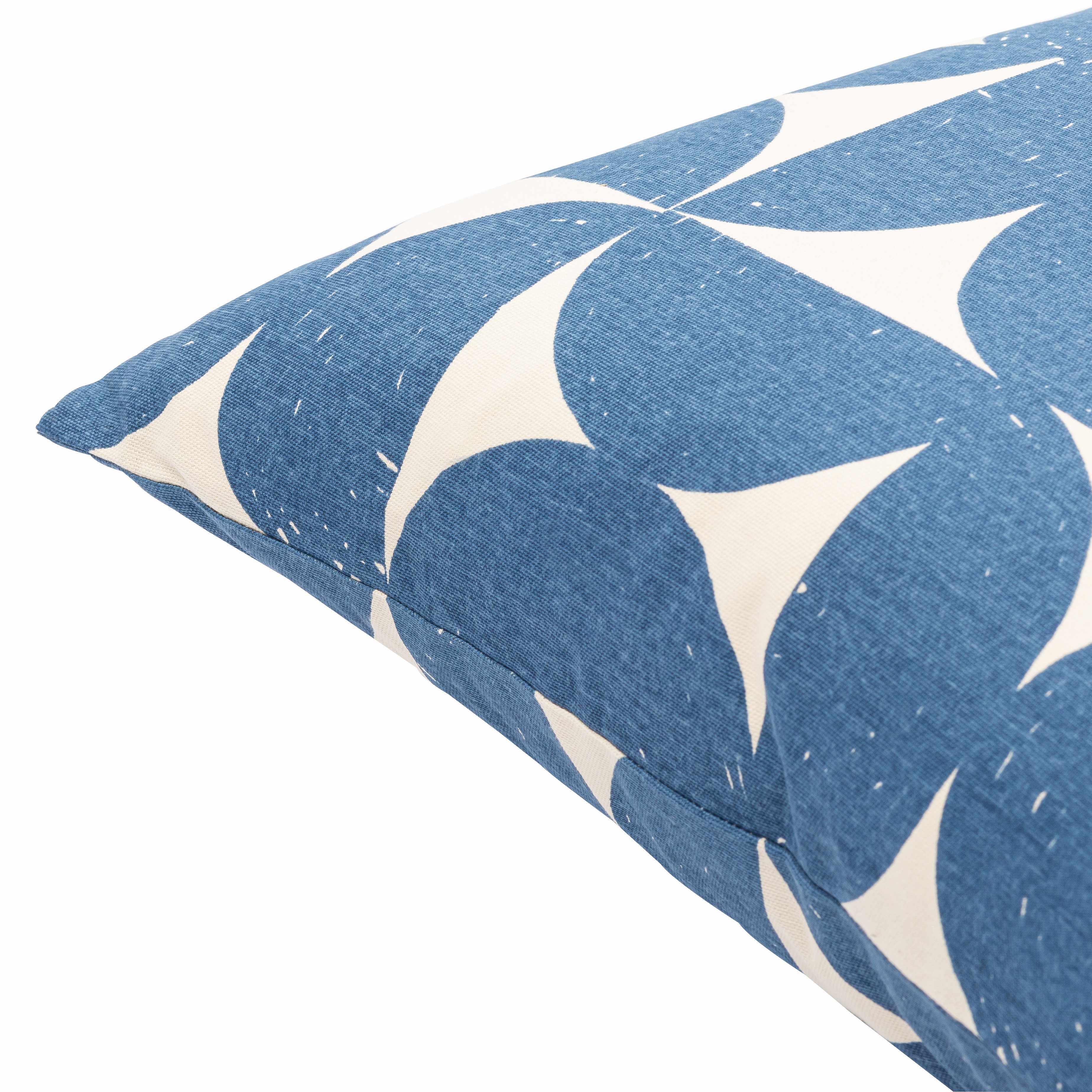 Blue and white patterned pillow on a white background
