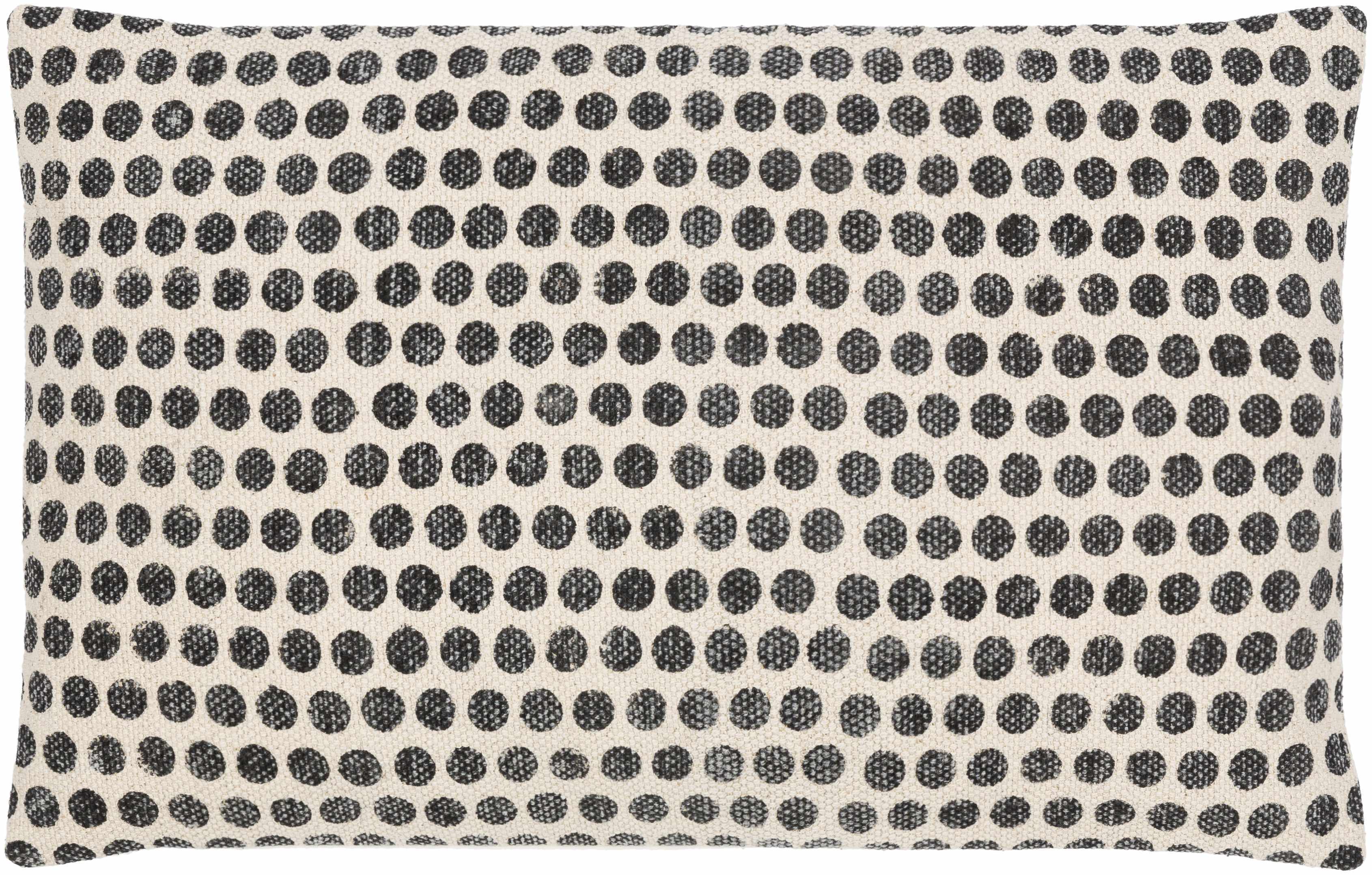Pillow with black dot pattern on beige background