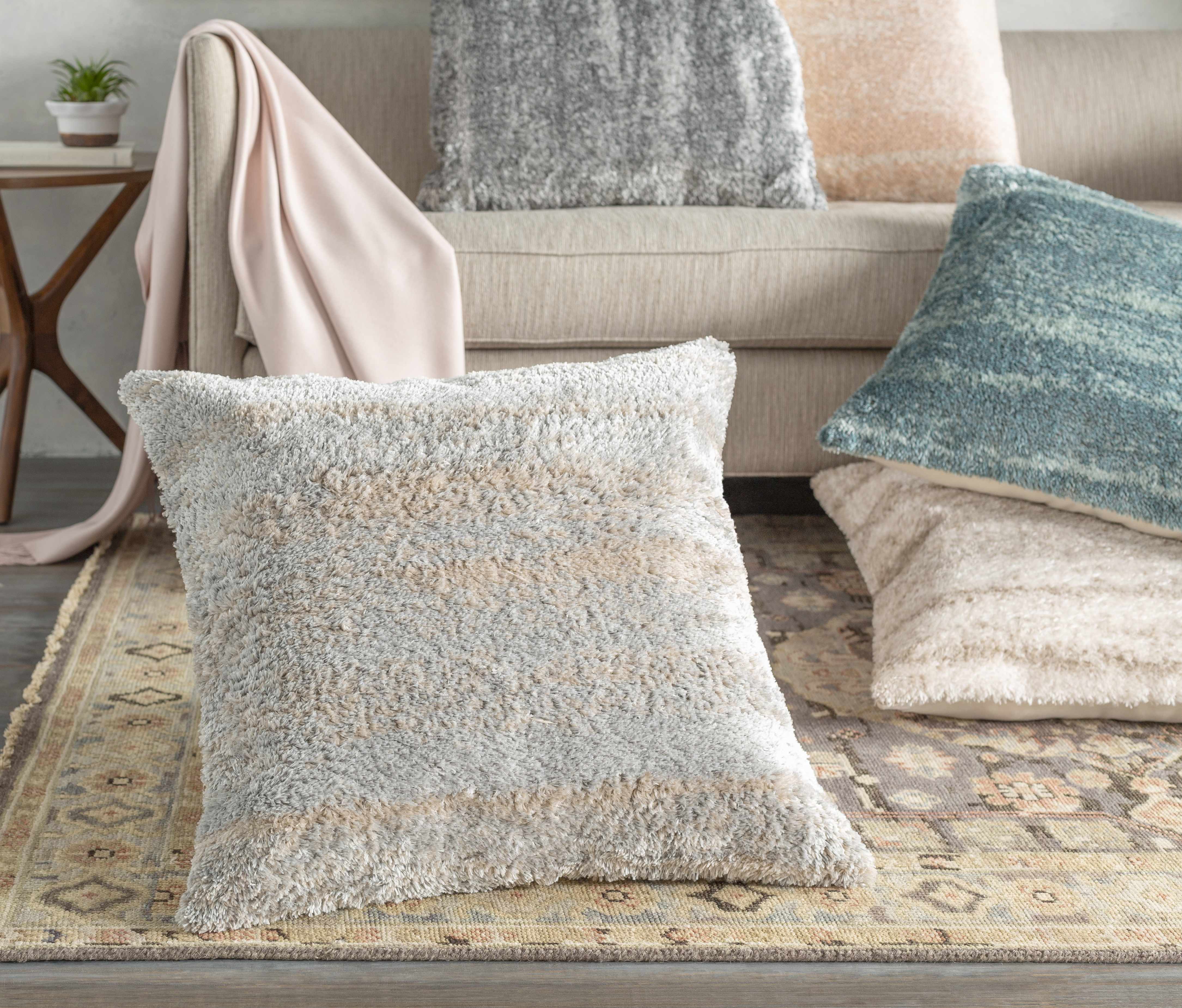 Textured throw pillow on a couch with a neutral color palette