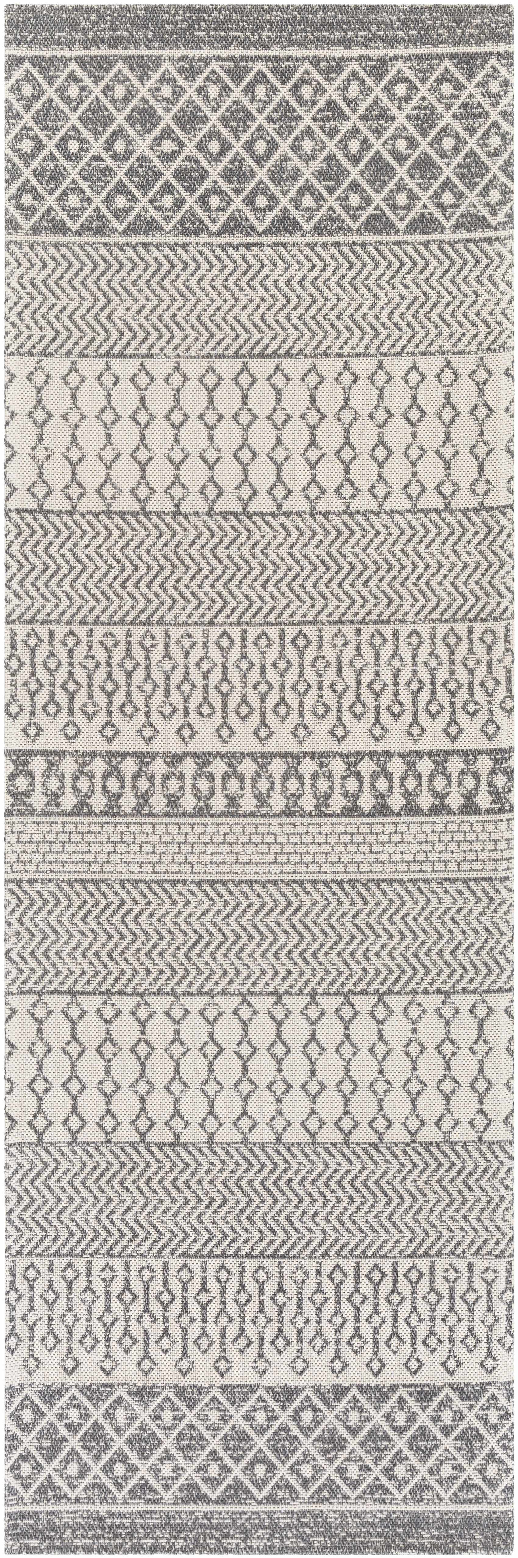 Patterned rug with geometric designs in gray and white