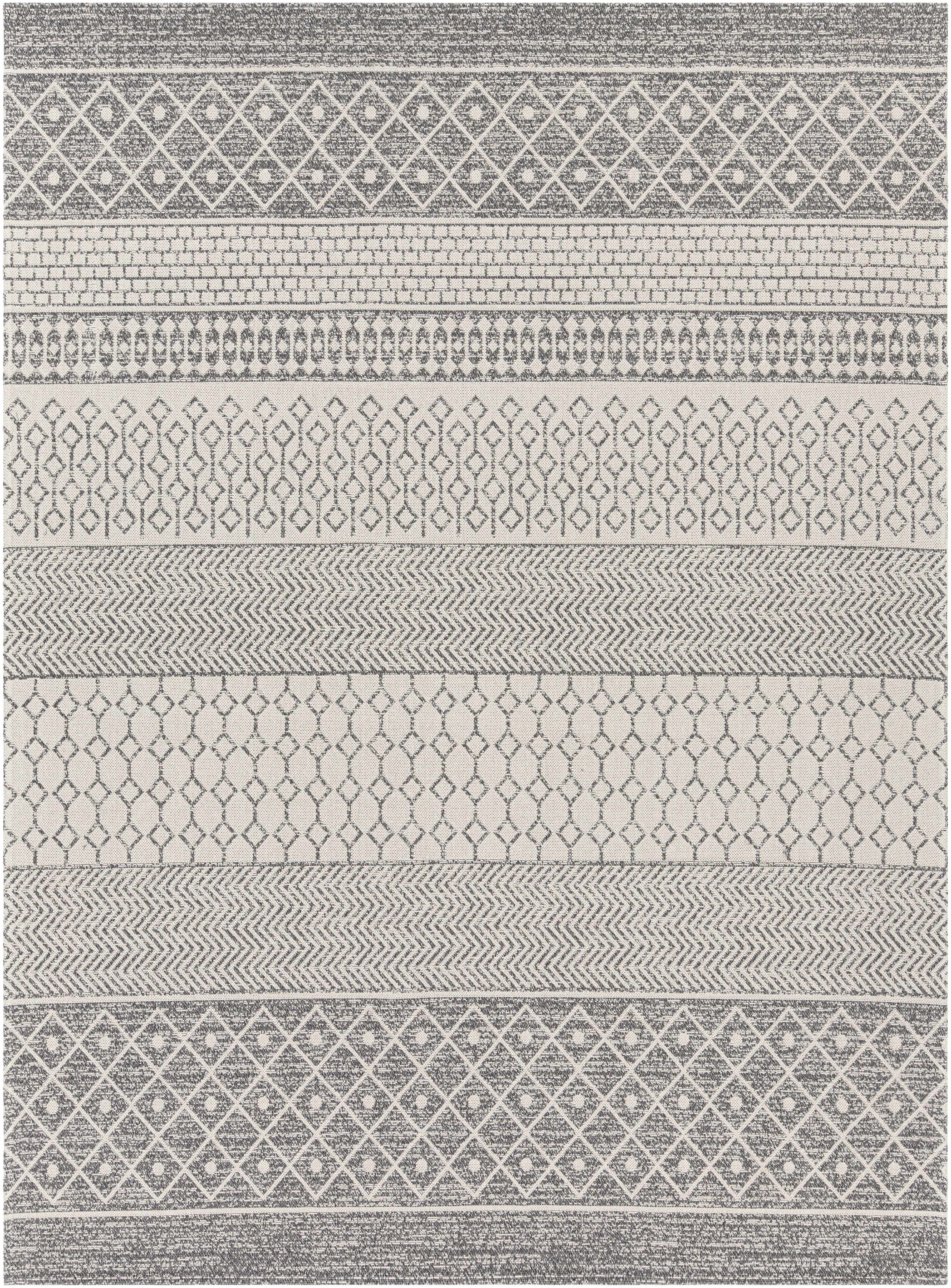 Patterned rug with geometric designs in gray and white