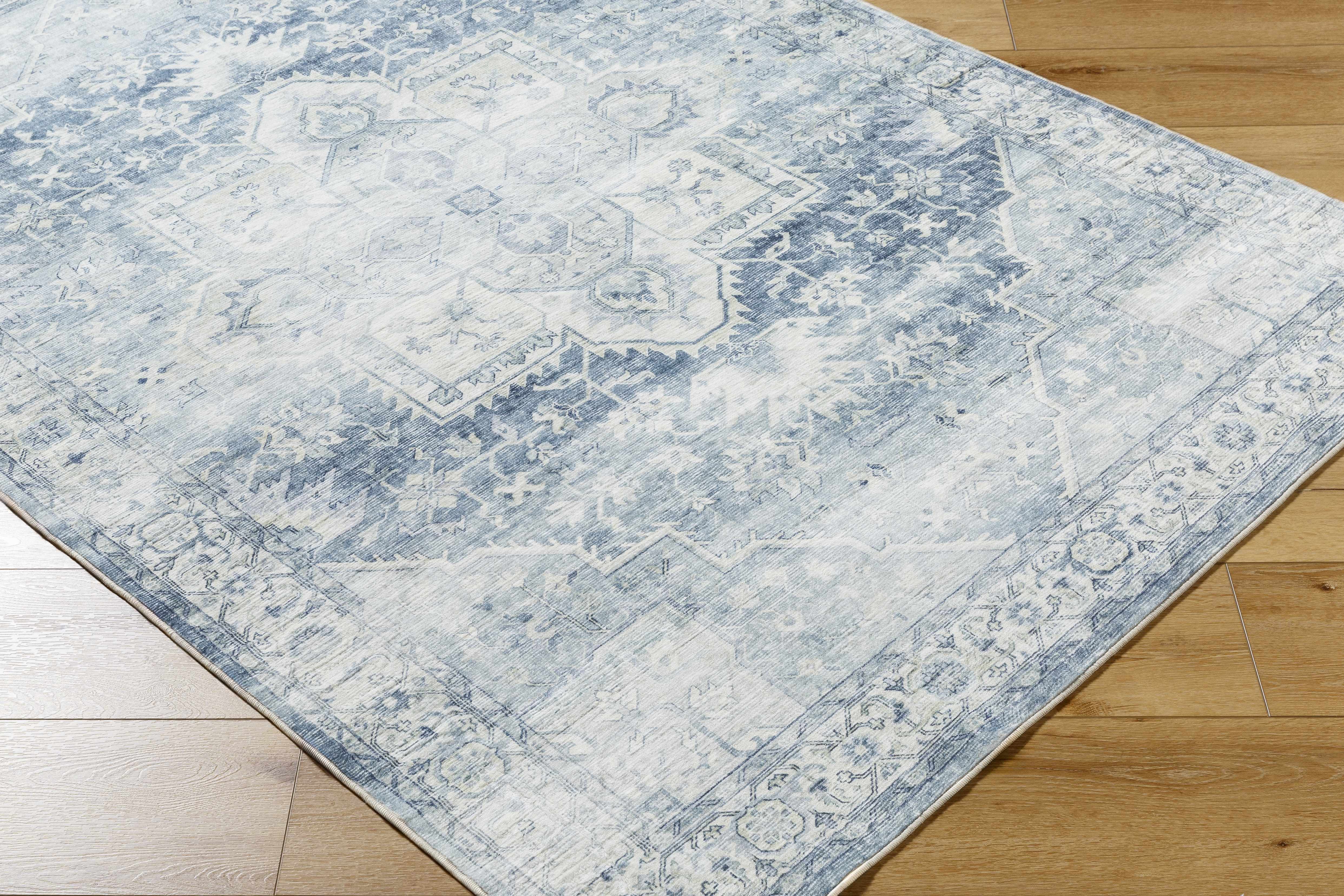 Blue and white patterned rug on a wooden floor