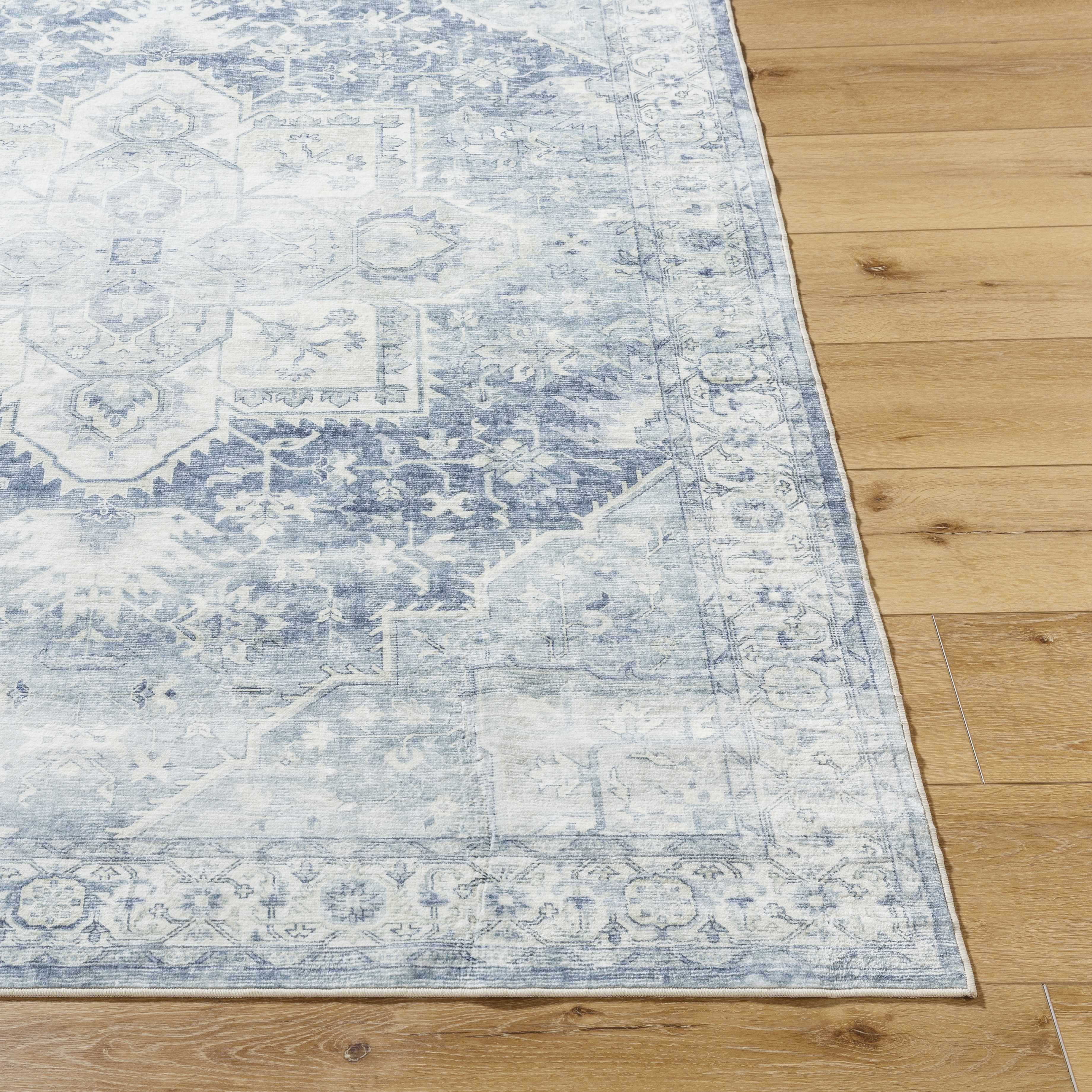 Blue and white patterned rug on a wooden floor