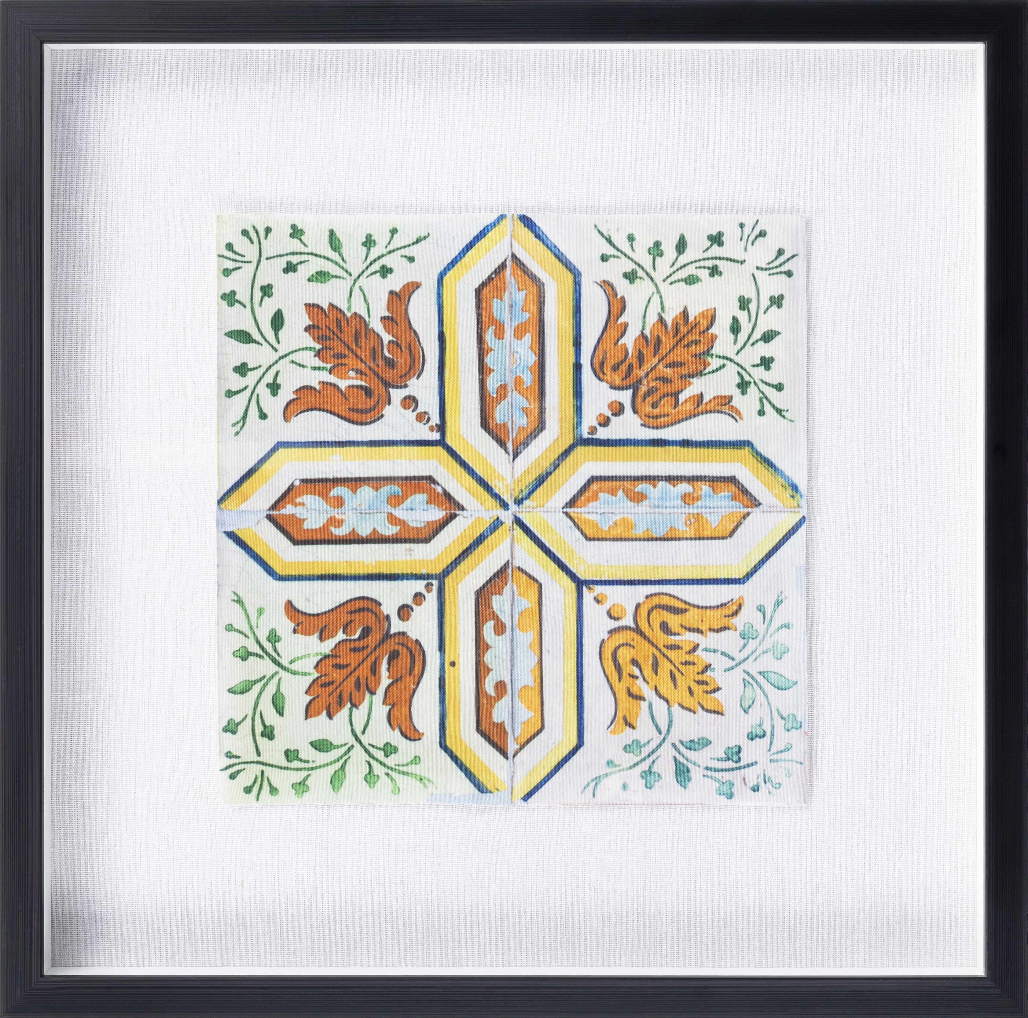 Decorative tile with floral patterns and geometric design in a black frame.