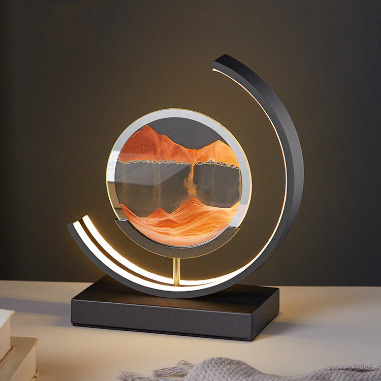 Decorative lamp with circular design and mountain landscape on a dark background