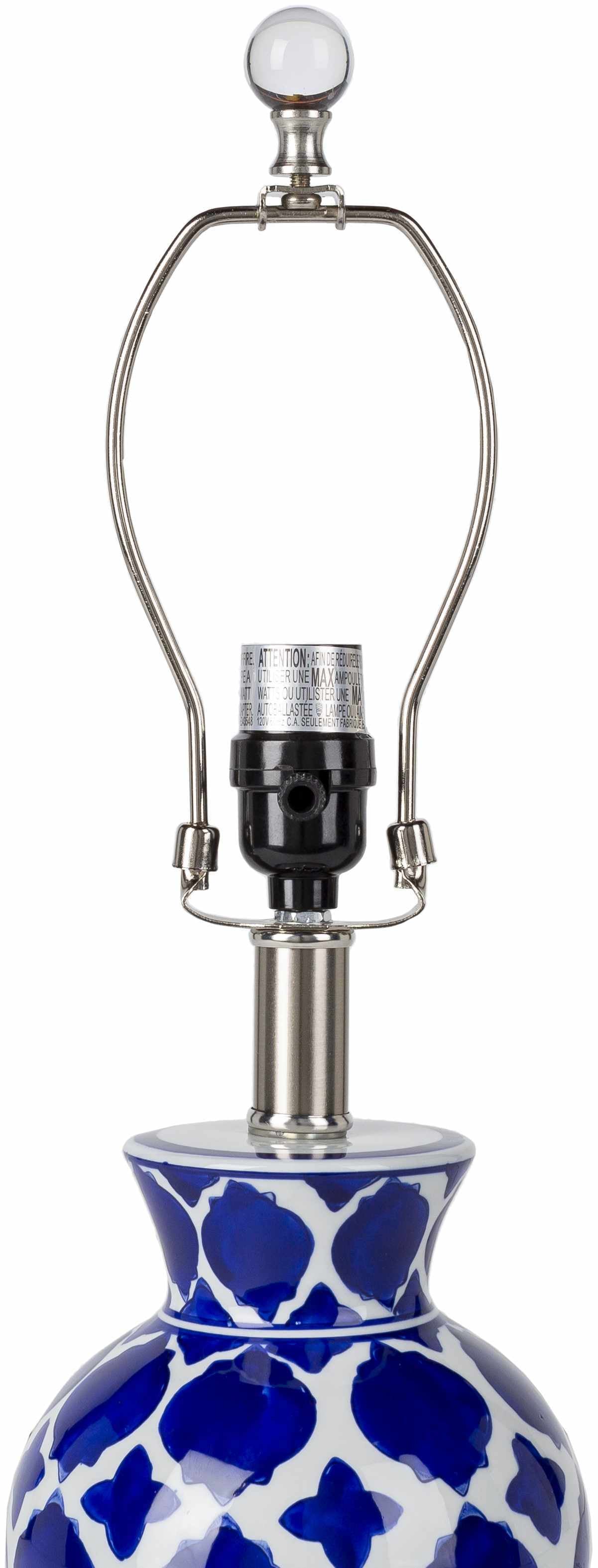 Table lamp with blue and white patterned base on a white background