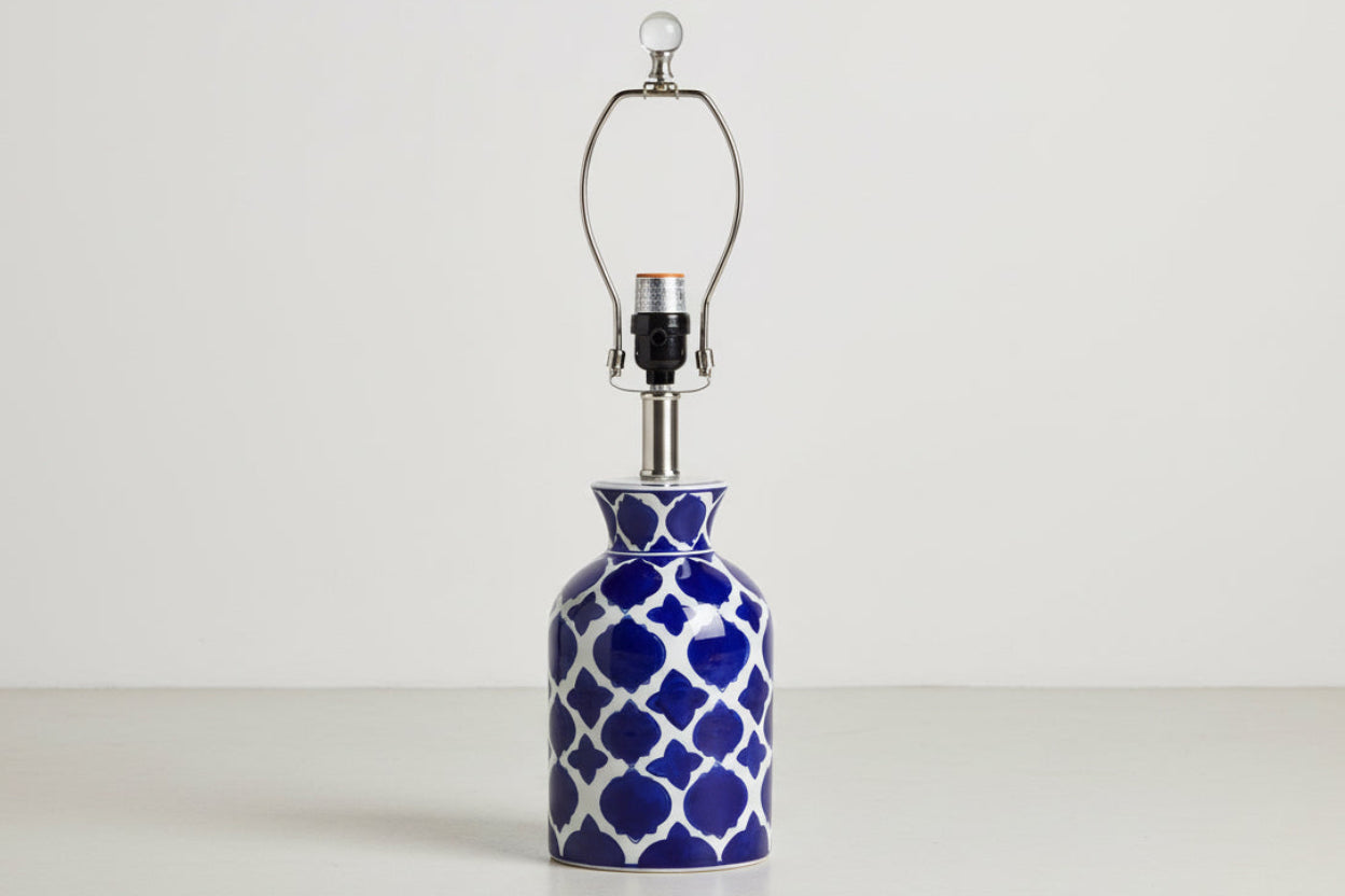 Table lamp with blue and white patterned base on a white background